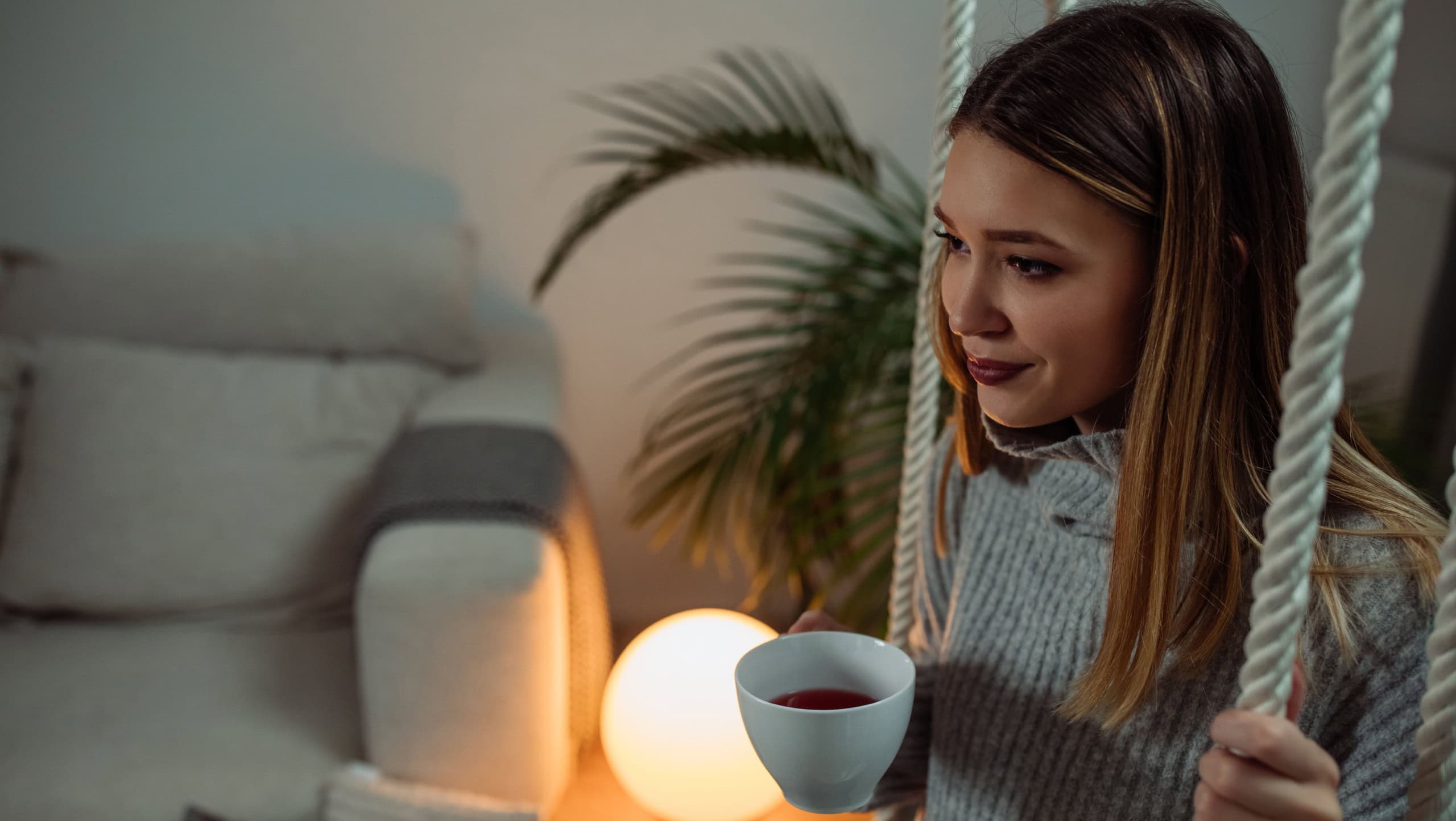 Young woman relaxing at home and drinking tea