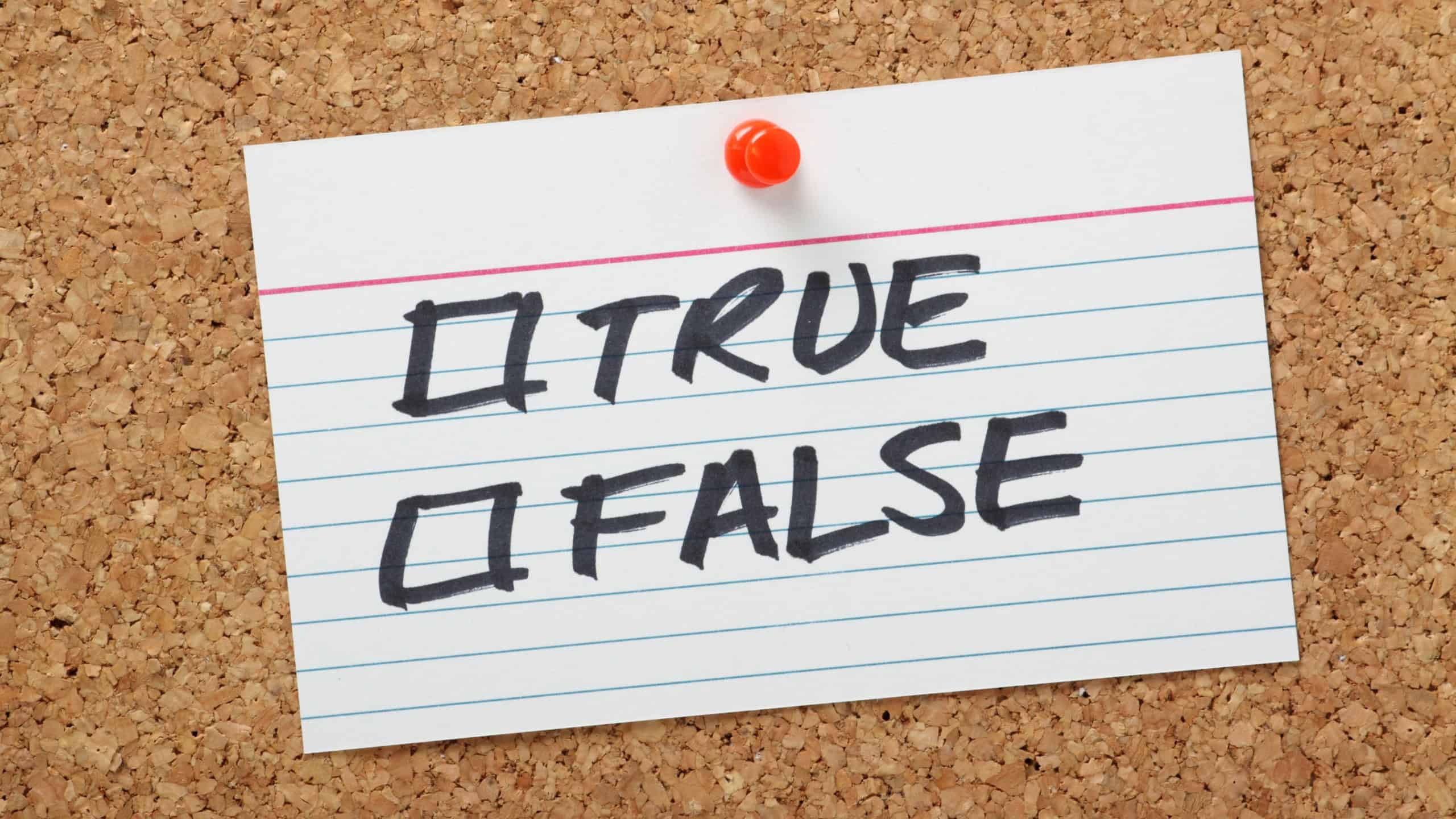 True or False tick boxes on a white note card pinned to a cork notice board