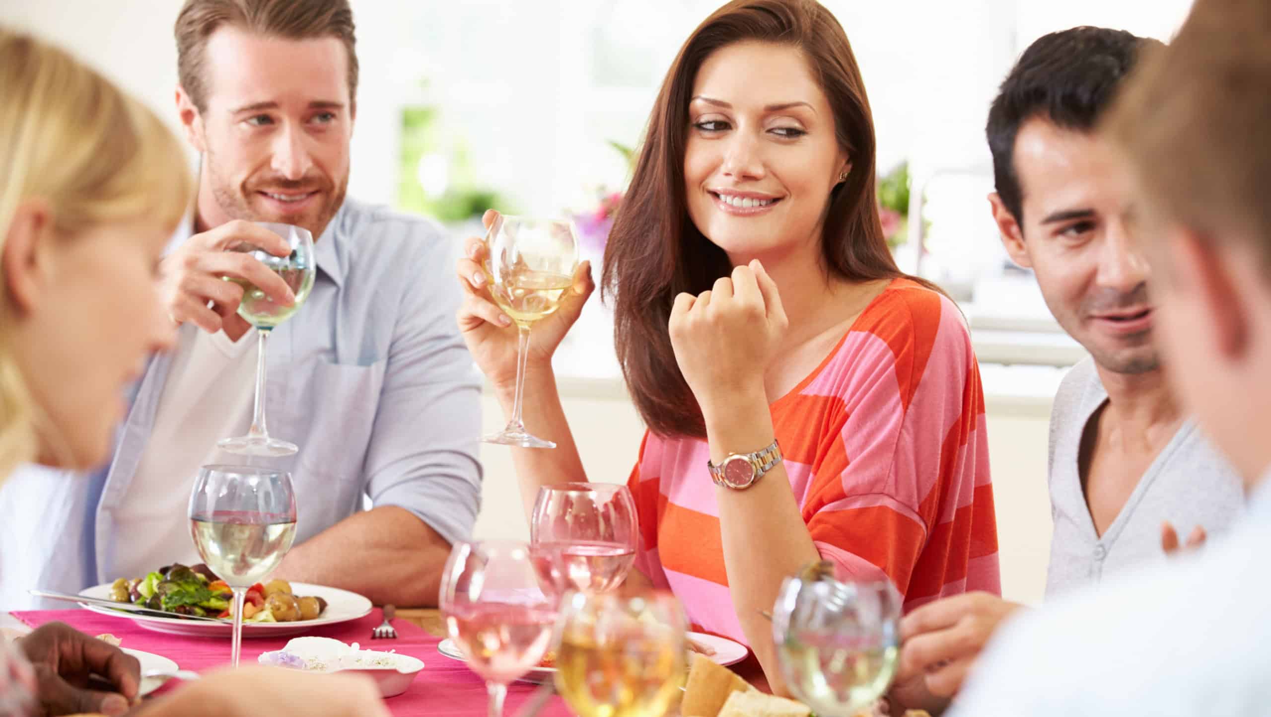 Group Of Friends Sitting Around Table Having Dinner Party