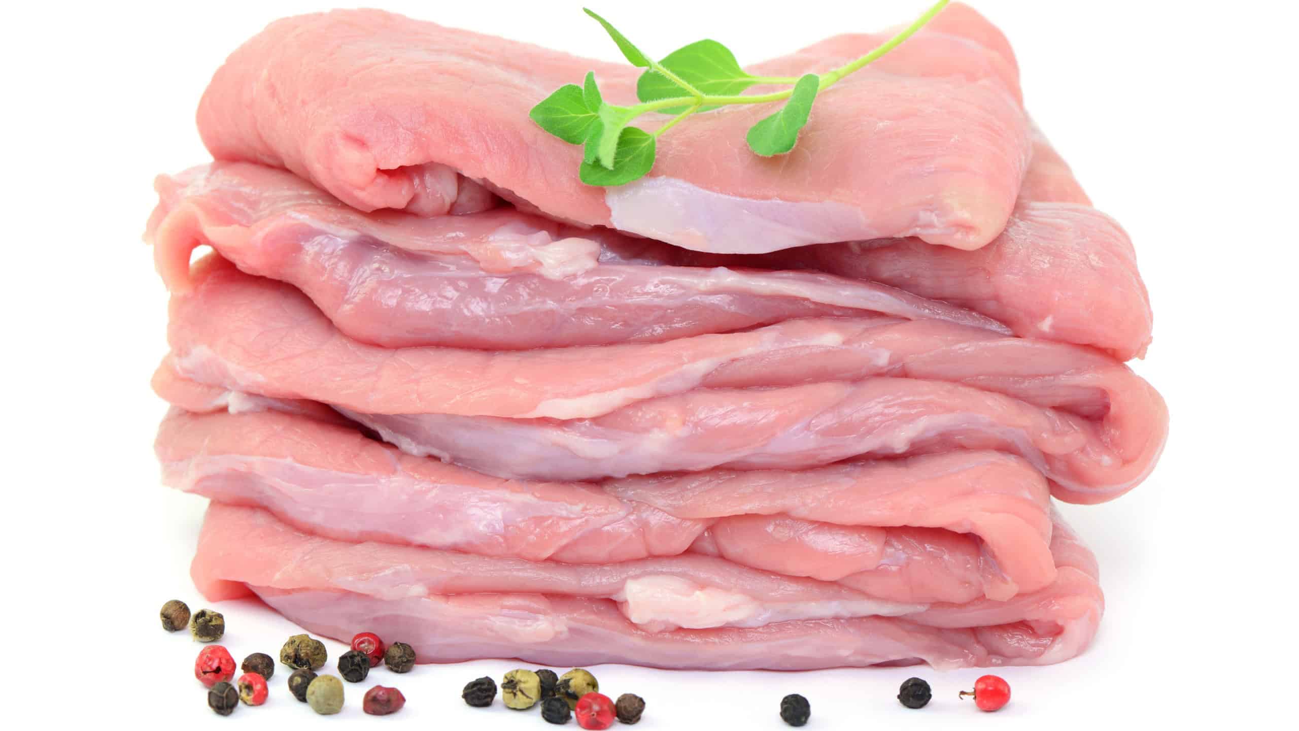 Raw meat with herbs and spices on white background