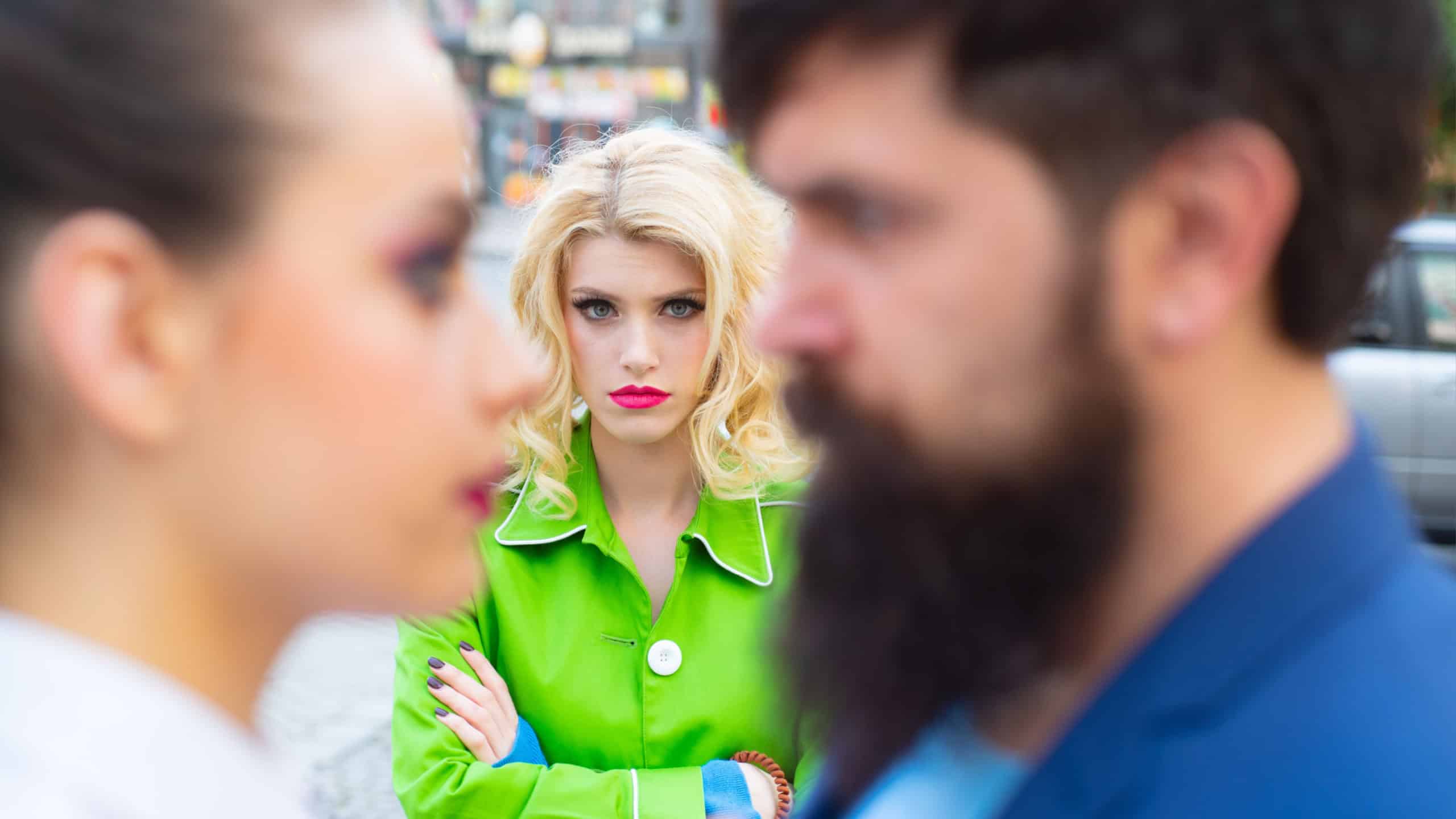 Really jealous of him. Jealous woman look at couple in love on street. Romantic couple of man and woman dating. Bearded man cheating his girlfriend with another woman. Unhappy girl feeling jealous