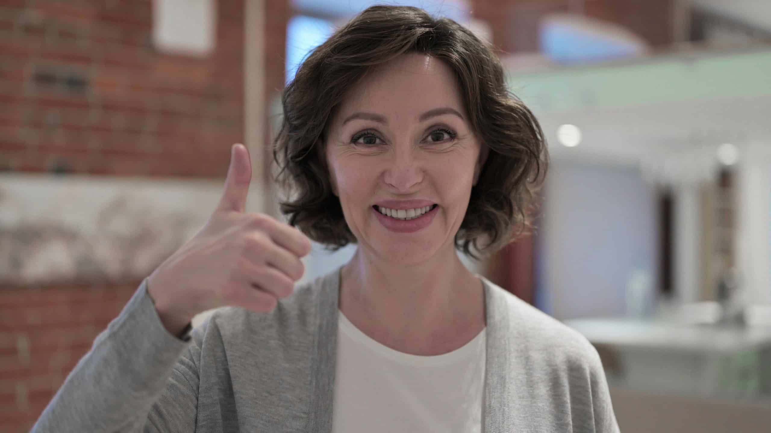 Portrait of Successful Old Woman showing Thumbs Up