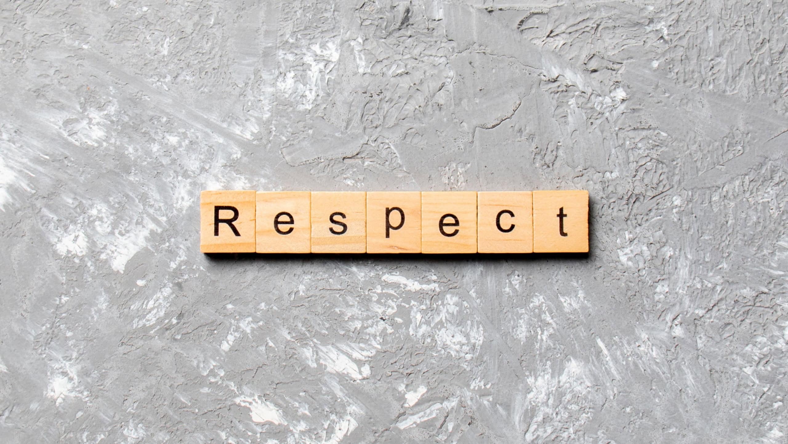 respect word written on wood block. respect text on table, concept.