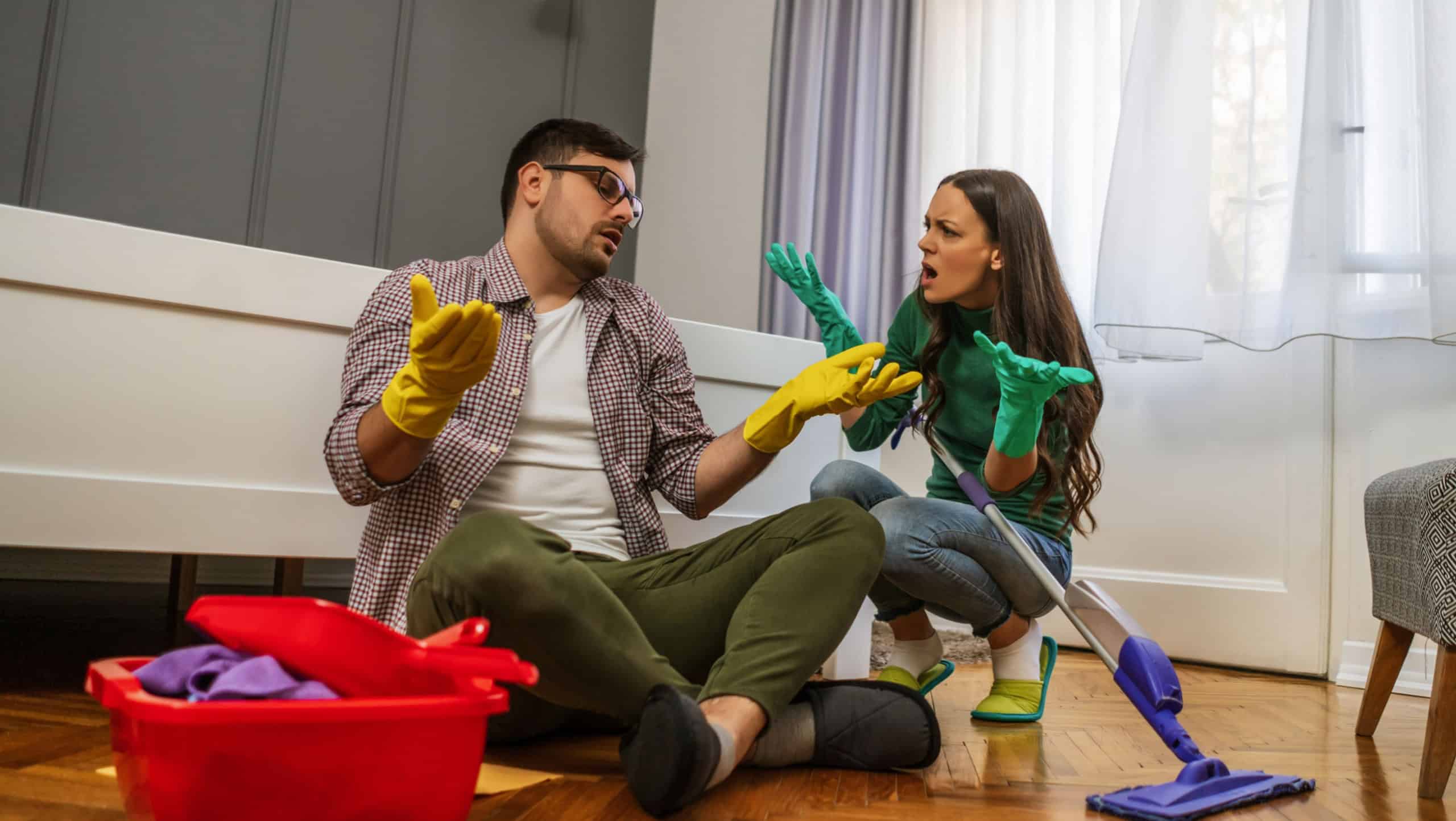 Man is lazy. His wife is telling him to continue cleaning their apartment.