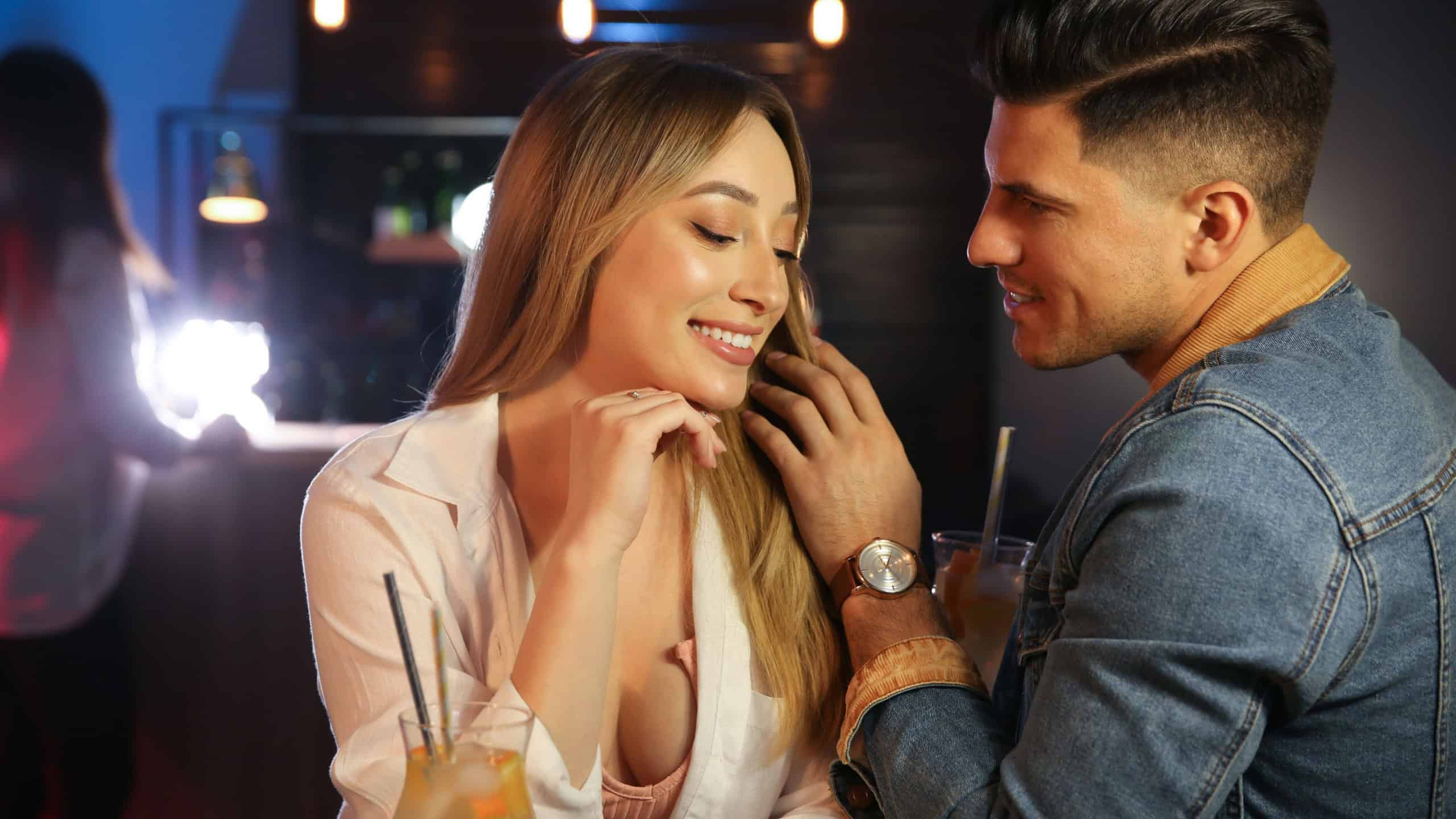 Man and woman flirting with each other in bar