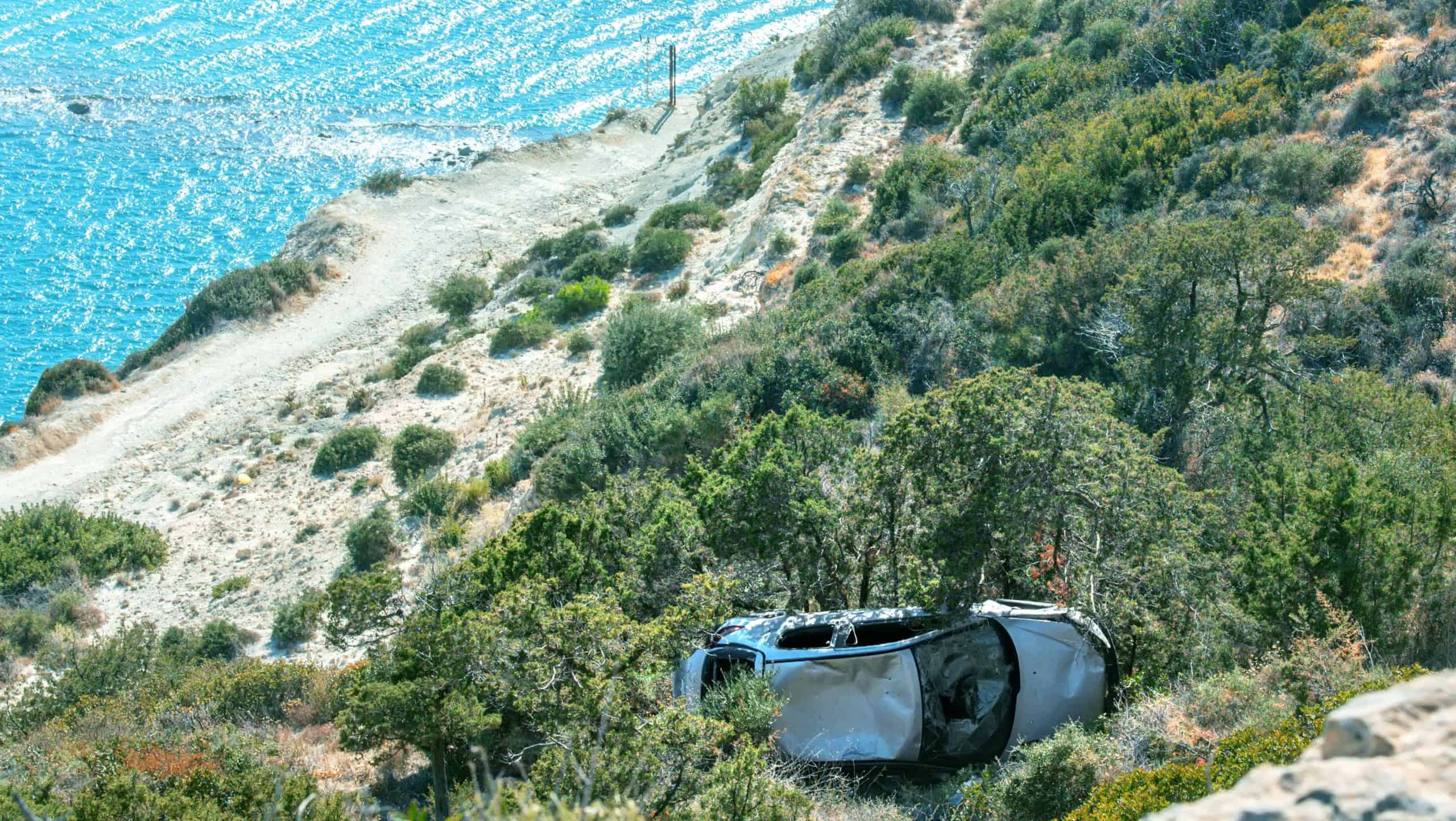 Car accident at Mediterranean, crashed car fallen from a cliff to sea coast