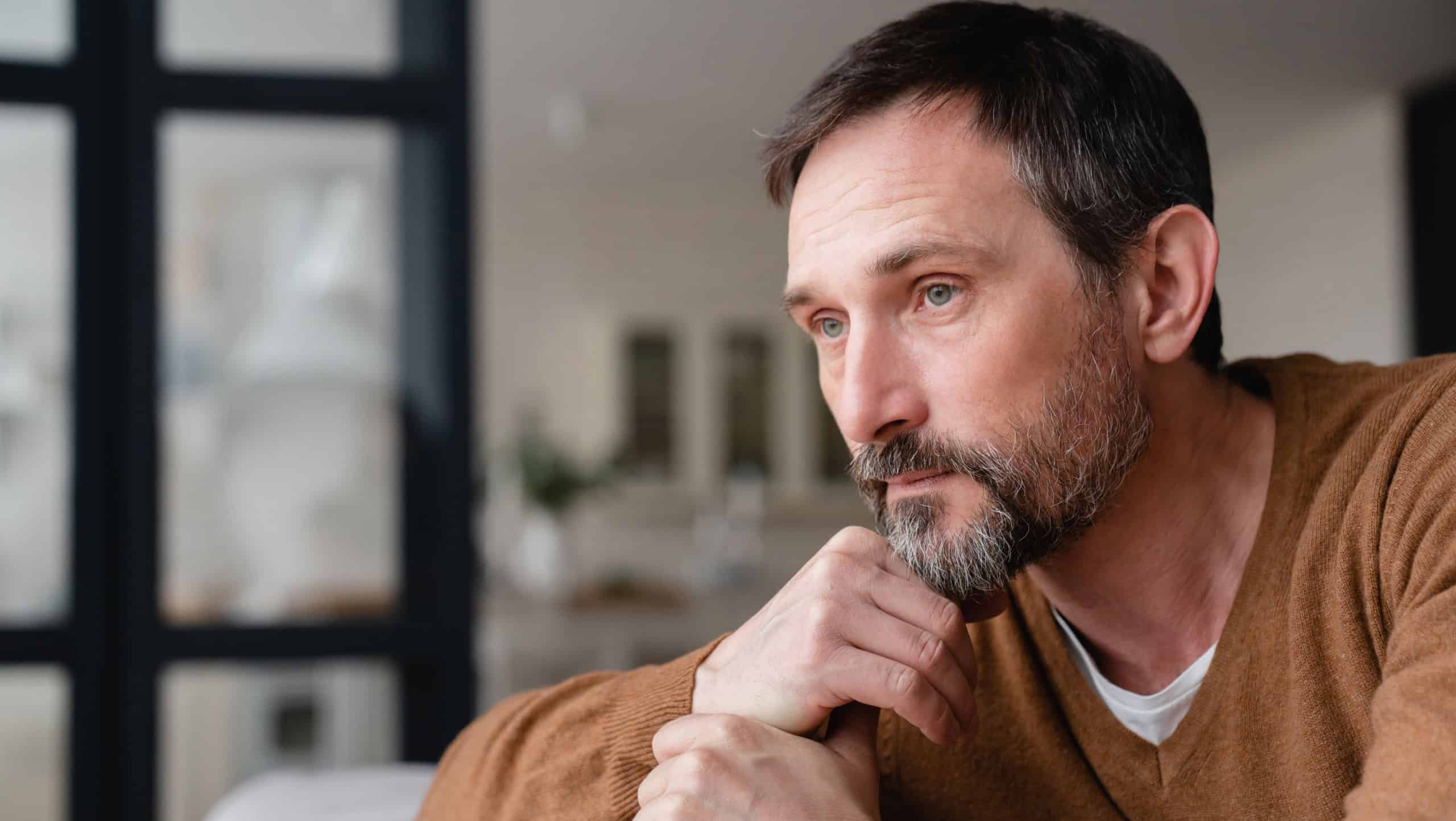 Sad mature middle-aged man depressed lonely having no visitors of his children. Divorce , bachelor , health problems concept. Lockdown, unemployment, needless man on social distance