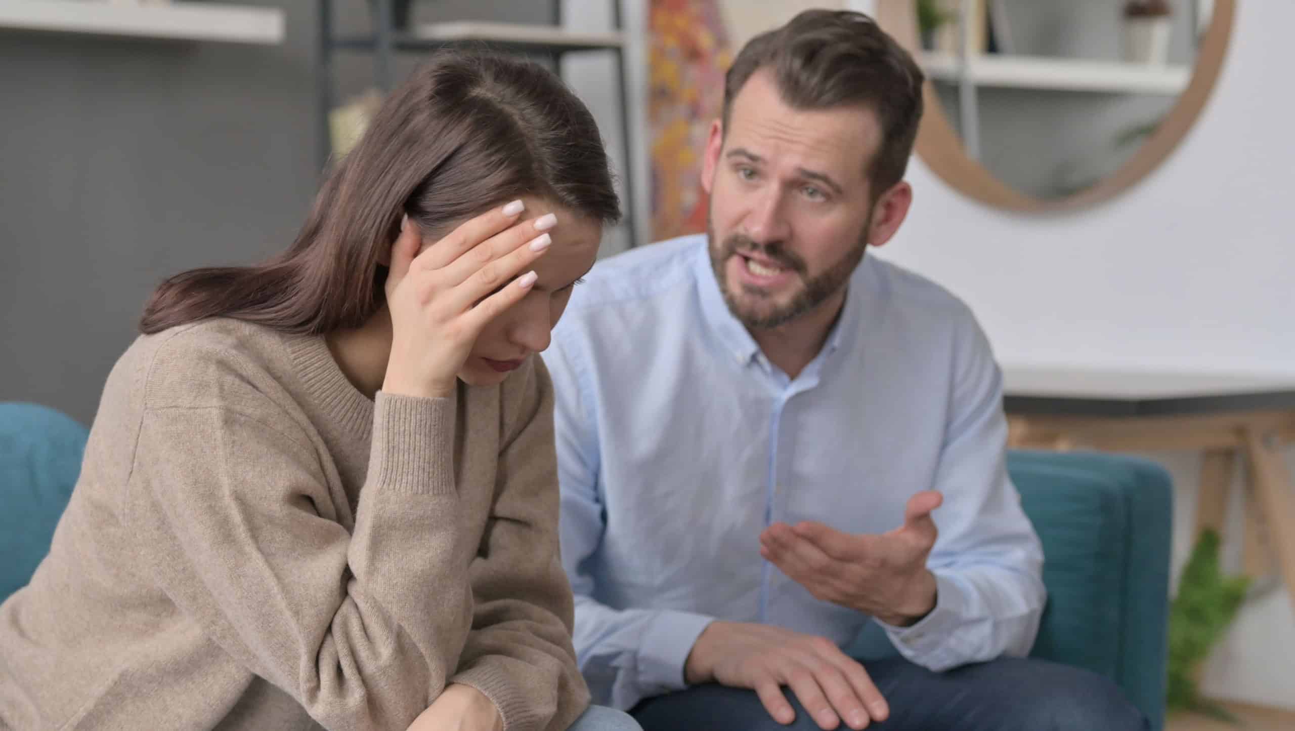 Man Arguing while Women Feeling Stressed on Sofa