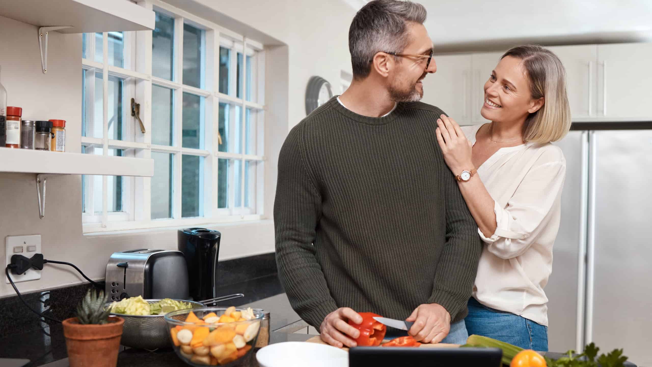 What are you cooking. Shot of a mature couple cooking together at home.