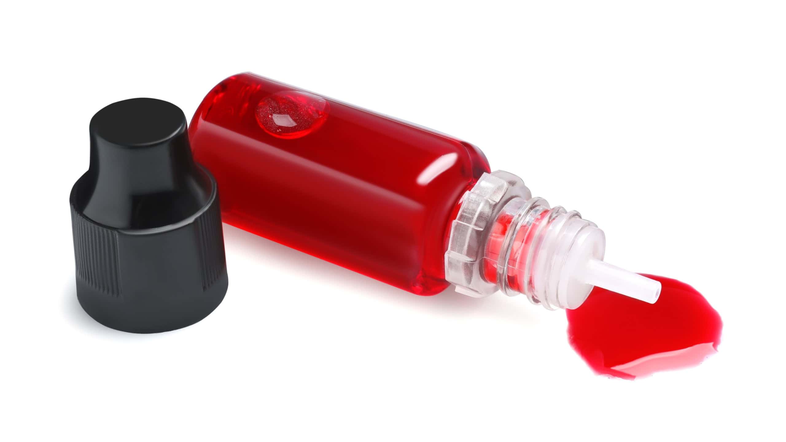 Bottle with red food coloring isolated on white