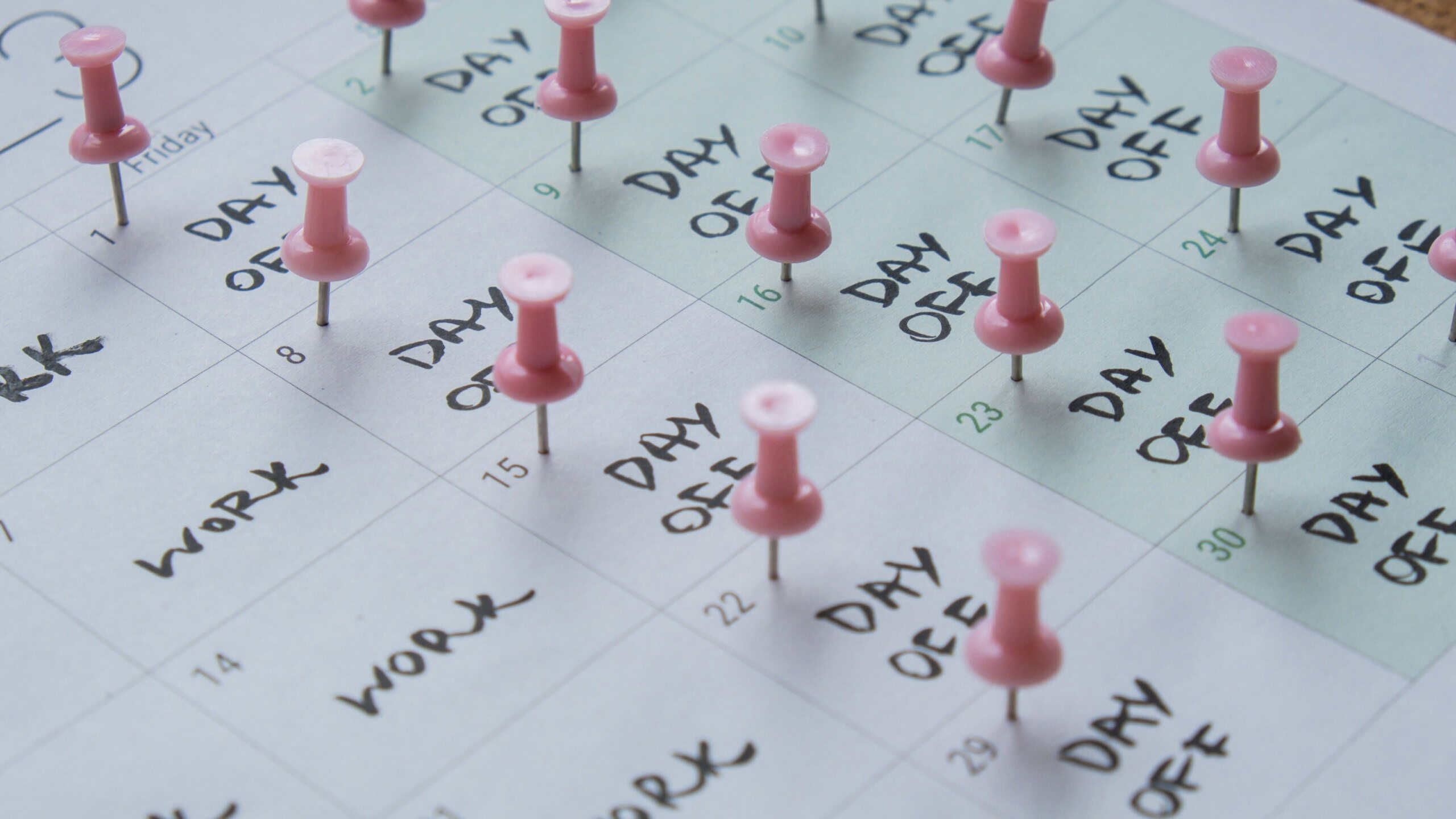 4 day work week printed calendar with pink pins on three days off in week weekend days four day working week concept. Modern approach doing business short workweek. Effectiveness of employees