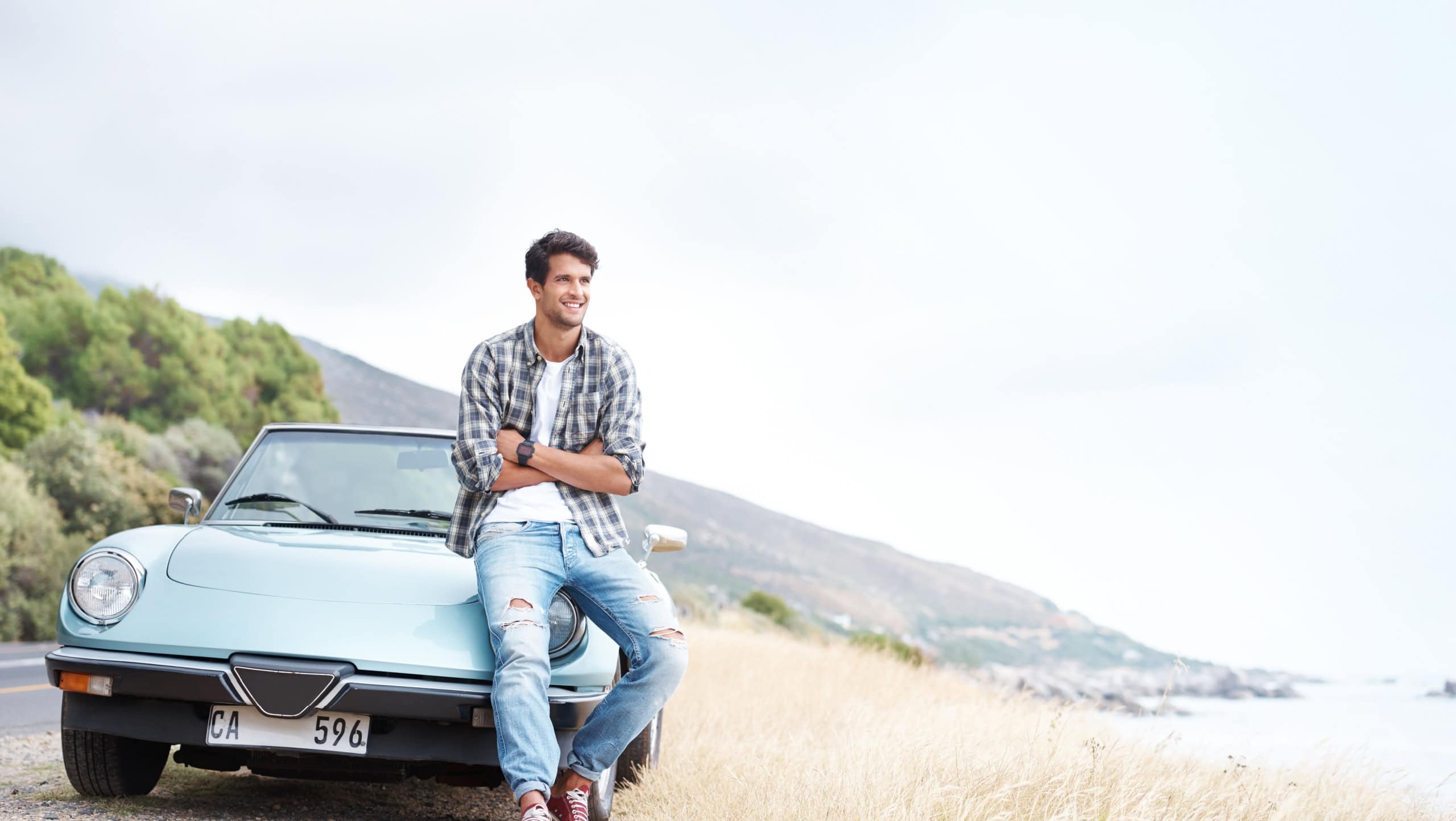 Thinking, car and man on road trip for holiday, travel or summer vacation outdoor in Italy. Transport, view and smile of confident person with arms crossed for adventure, mockup and space on journey