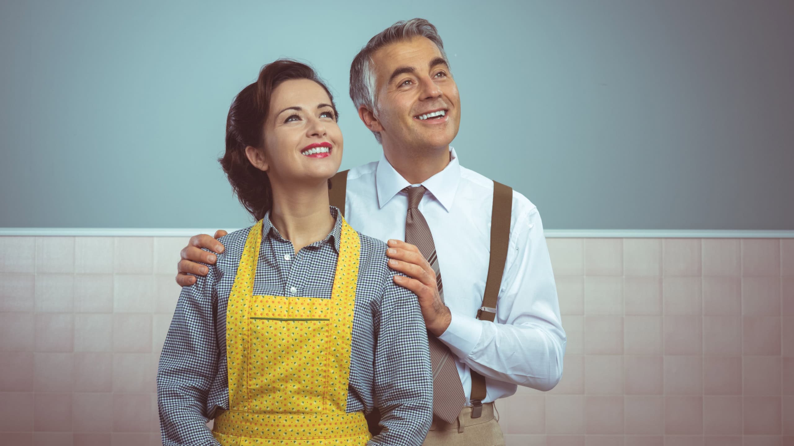 Happy vintage couple at home posing and smiling at camera
