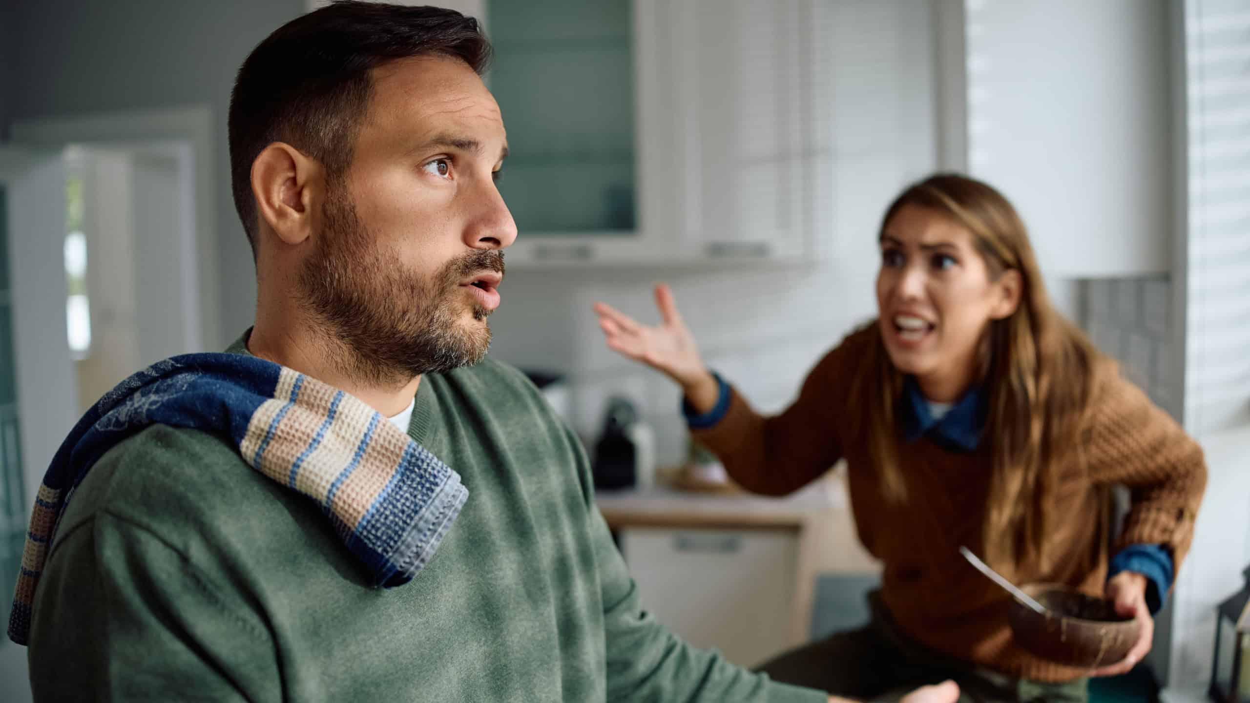 Man and woman having a heated argument in the kitchen.