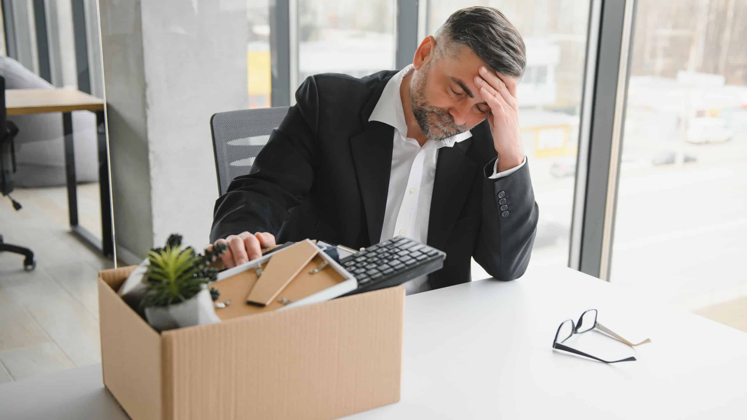 Old male employee being fired from his work.