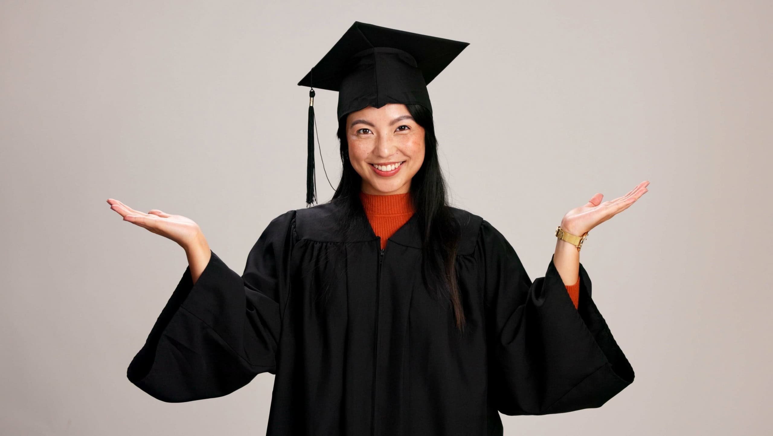 Hands, graduation and choice with portrait of asian woman in studio for success, college degree or decision. Option, education and university student with person on white background for mockup space