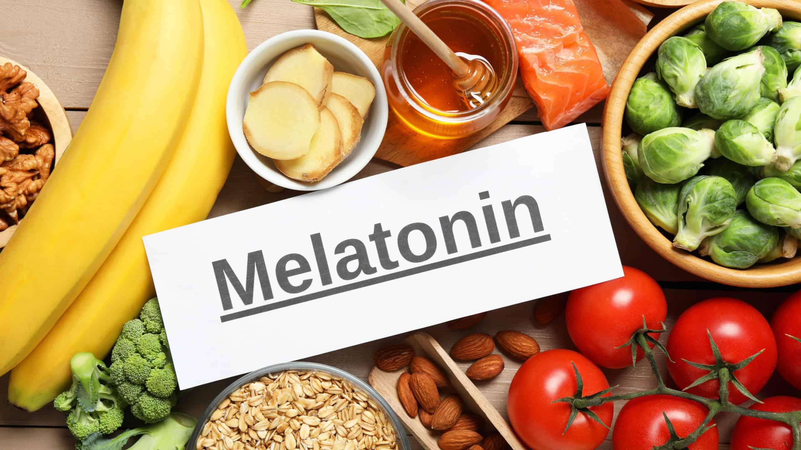 Word Melatonin and different products on wooden table, flat lay