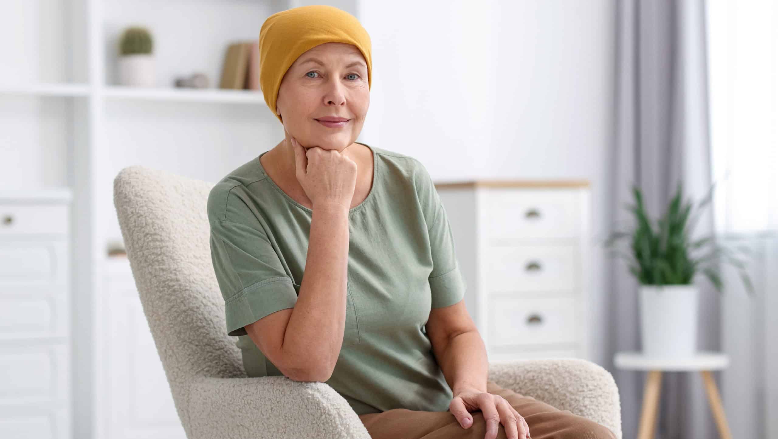 Senior woman with cancer on armchair at home