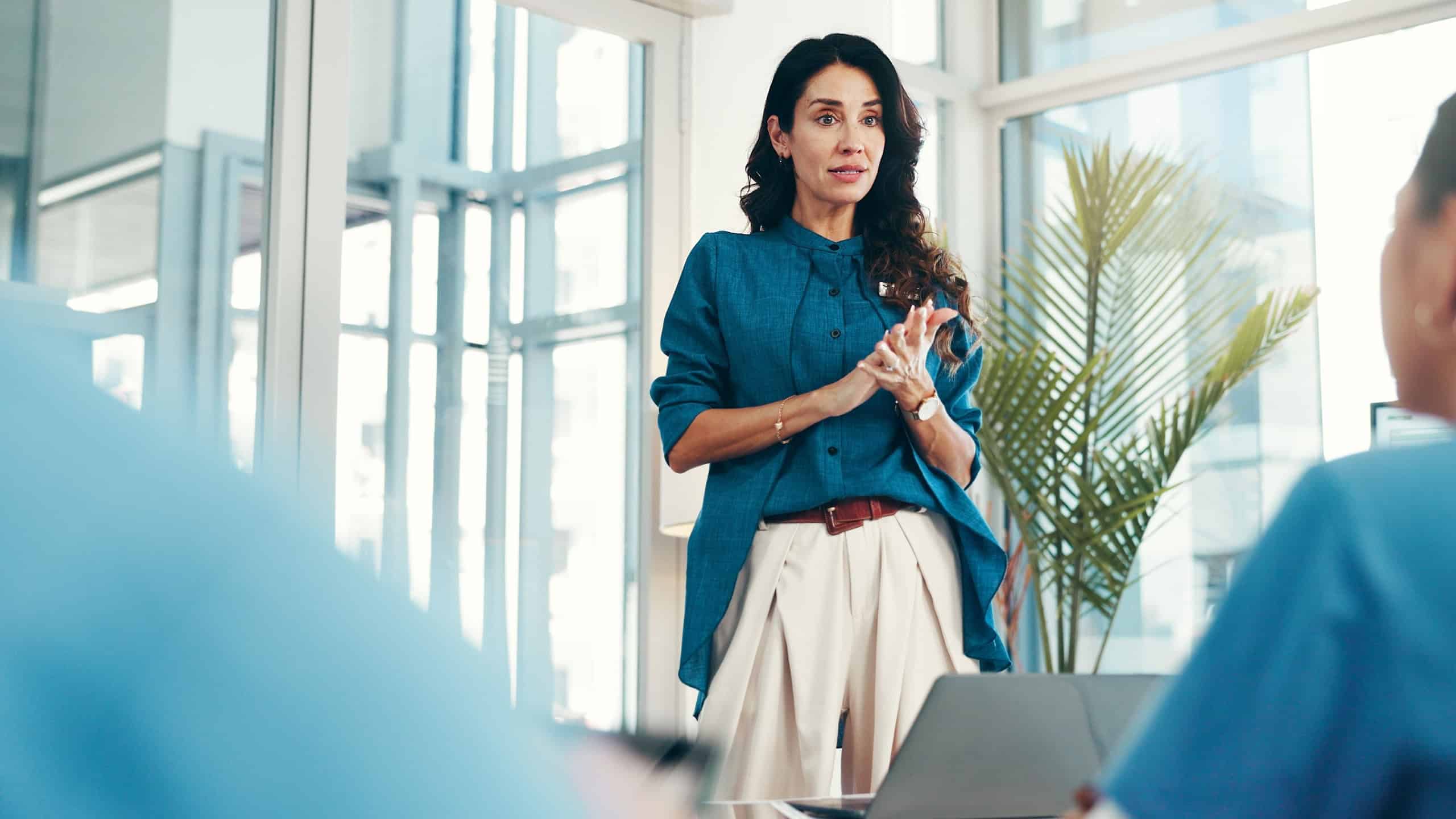 Woman, healthcare speaker or people in presentation or wellness with nurses for research development. Group, teamwork or doctors in meeting for plan, medical review or funding feedback in hospital