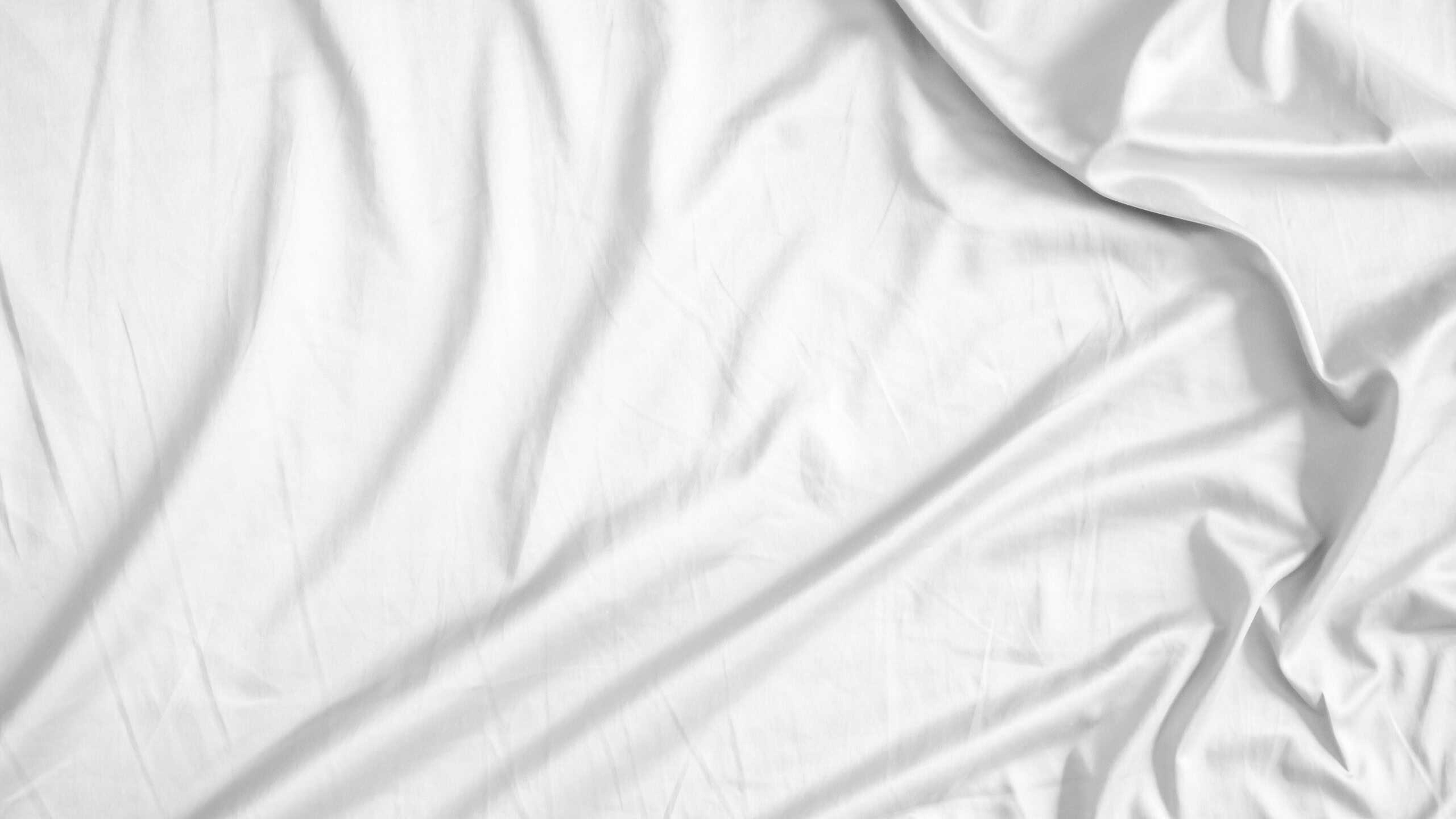 Abstract white wrinkled bedding sheet fabric texture background