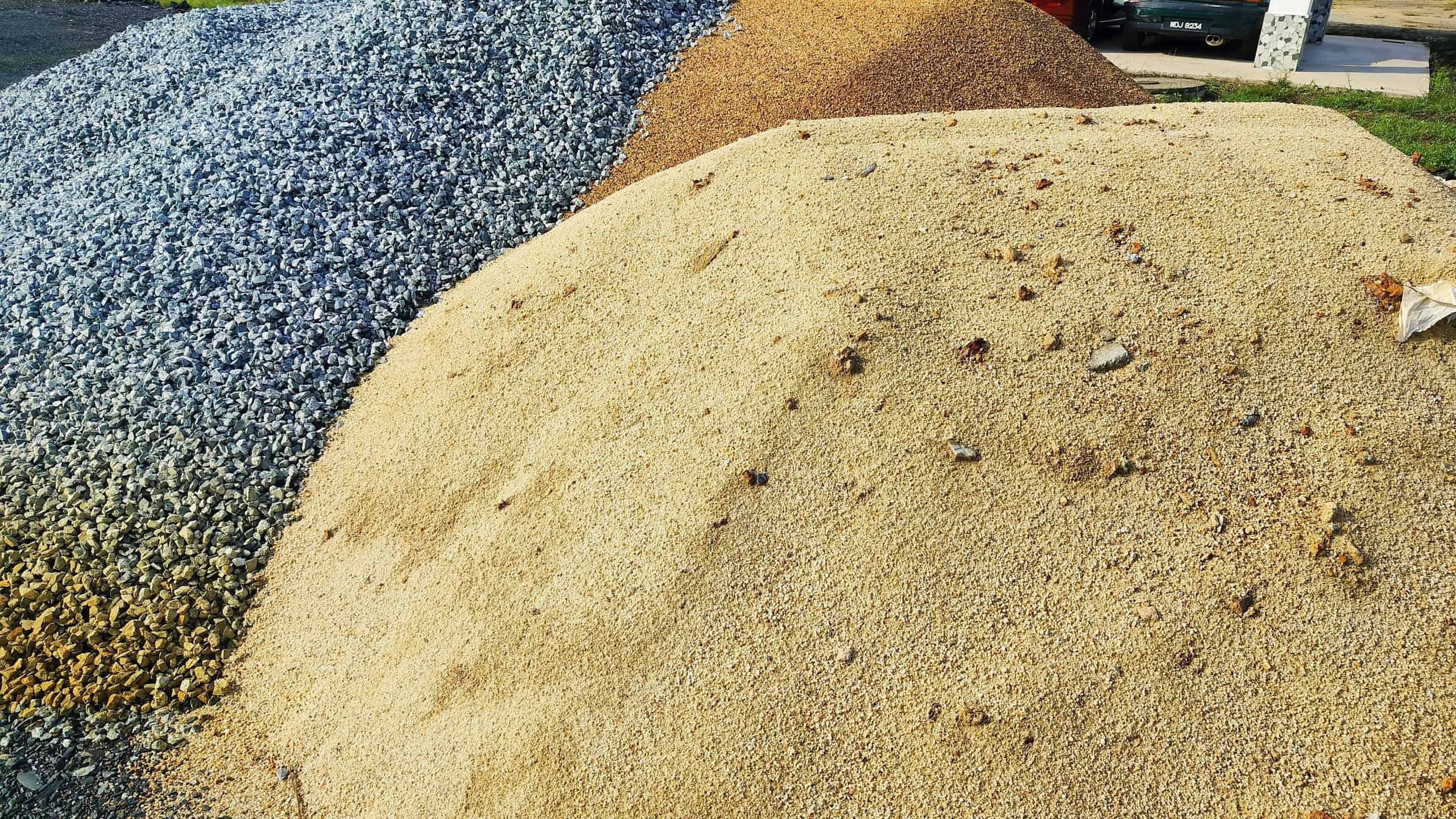 Pile of sand and stones to build a house. gravel or stone and sand in construction site. Materials for construction, sand, crushed stone