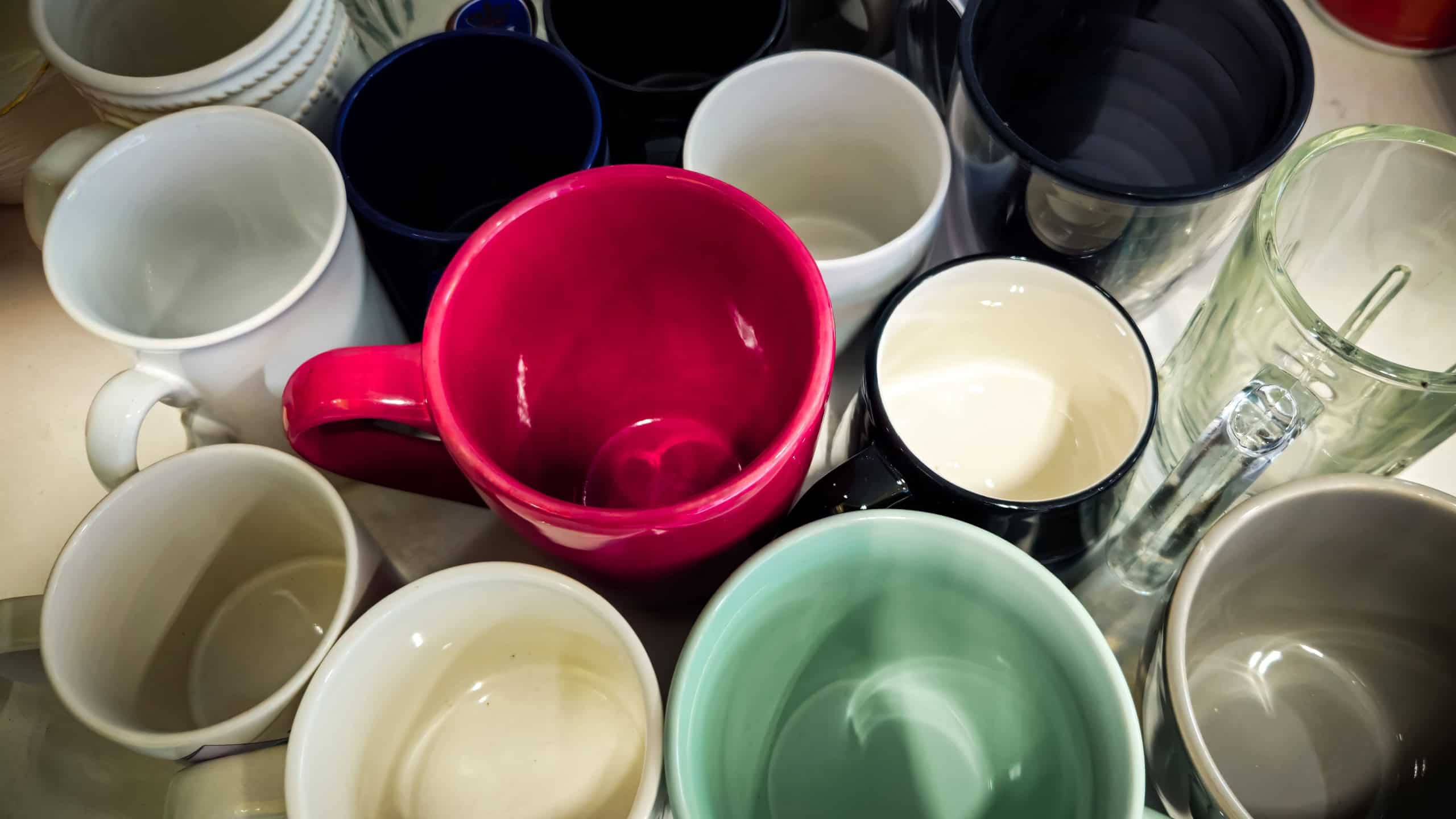 A collection of various mugs and cups clustered together. Decluttering or organization design element.
