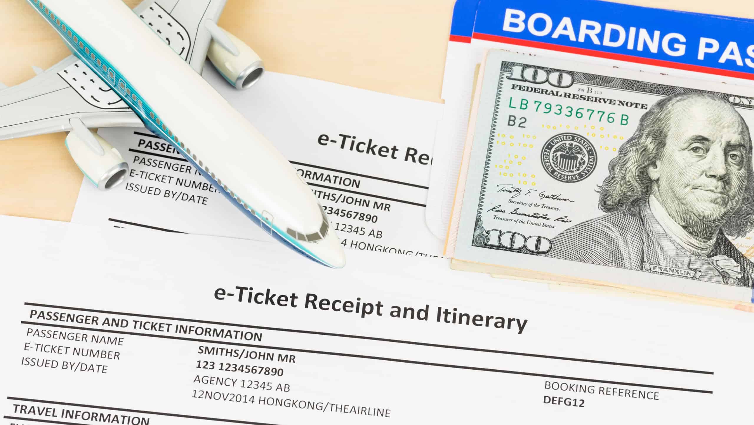 E-ticket with plane model, banknote, and boarding pass; these documents are mock-up