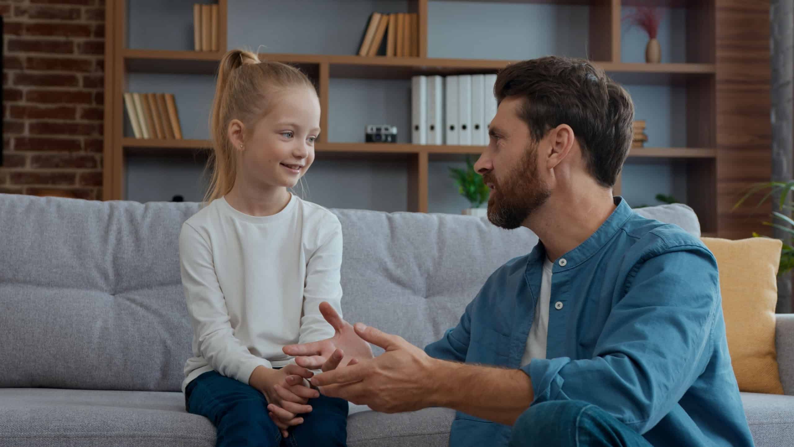 Caucasian family communication at home serious parent father talk with daughter explain dad talking to little child kid girl conversation in living room childcare parenthood fatherhood adopt custody