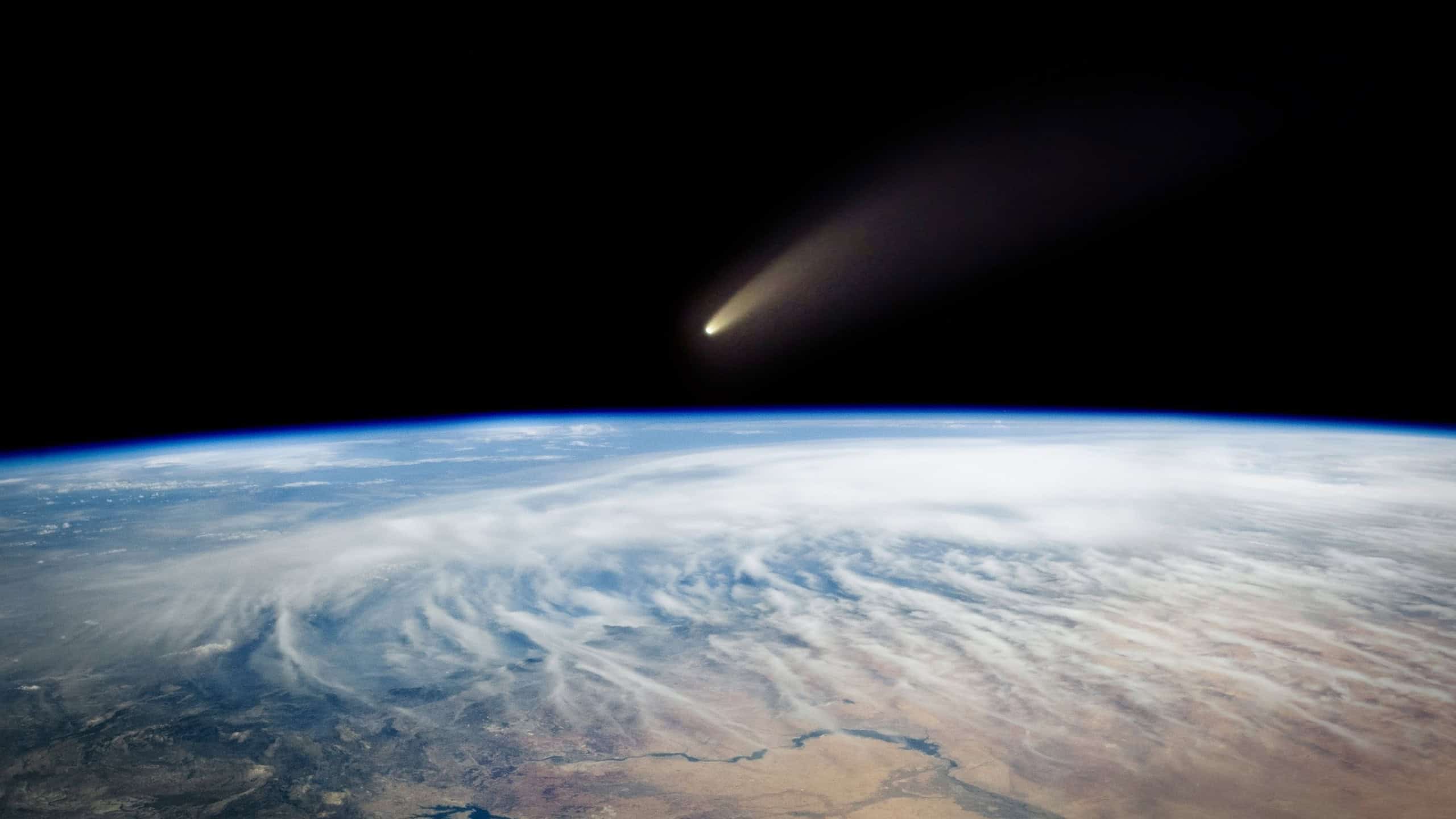Comet, asteroid, meteorite flying to the planet Earth. Glowing asteroid and tail of a falling comet threatening the safety of the Earth. Elements of this image furnished by NASA.
