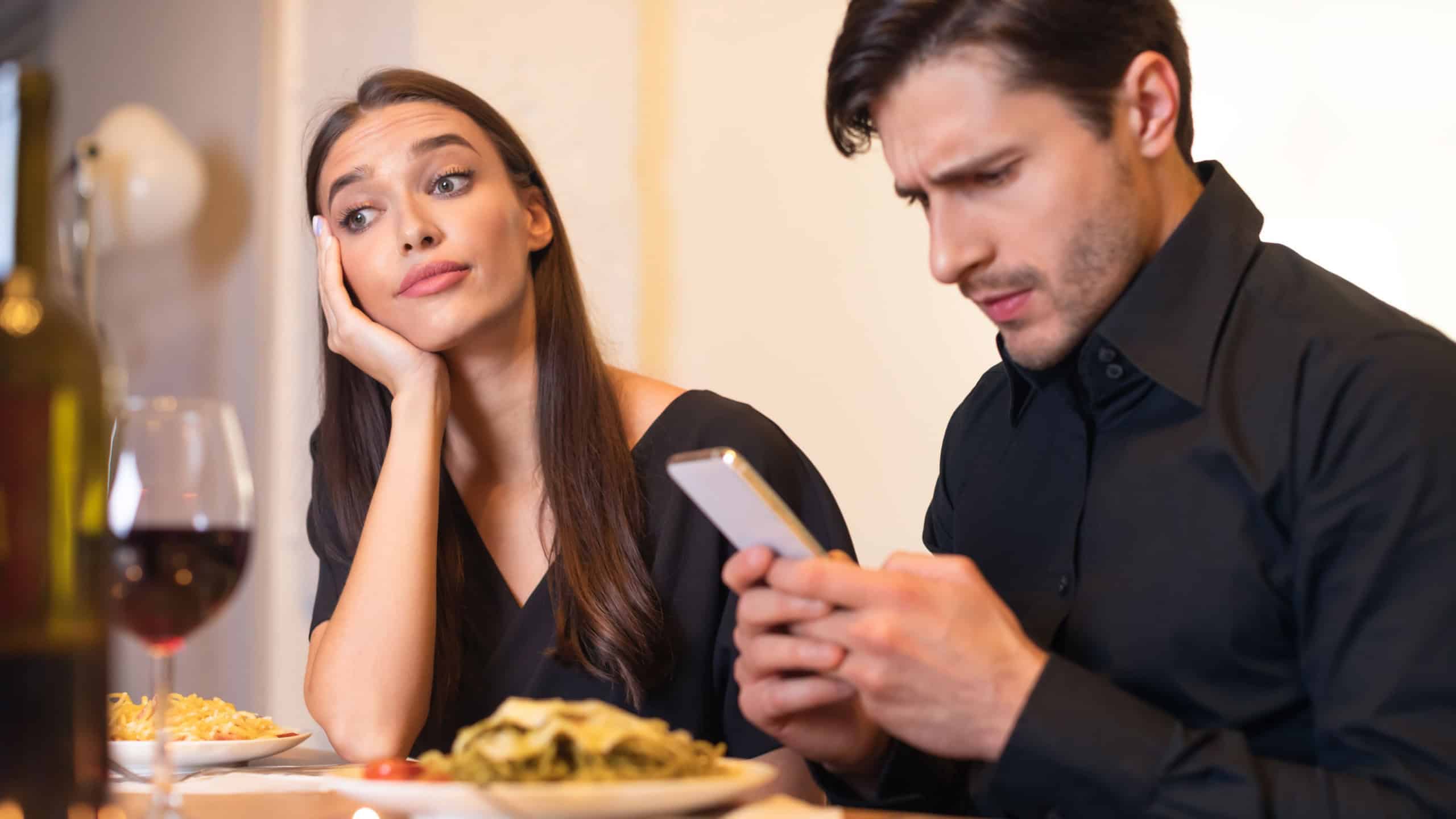 Unhappy Woman Bored On Date, Man Using Phone