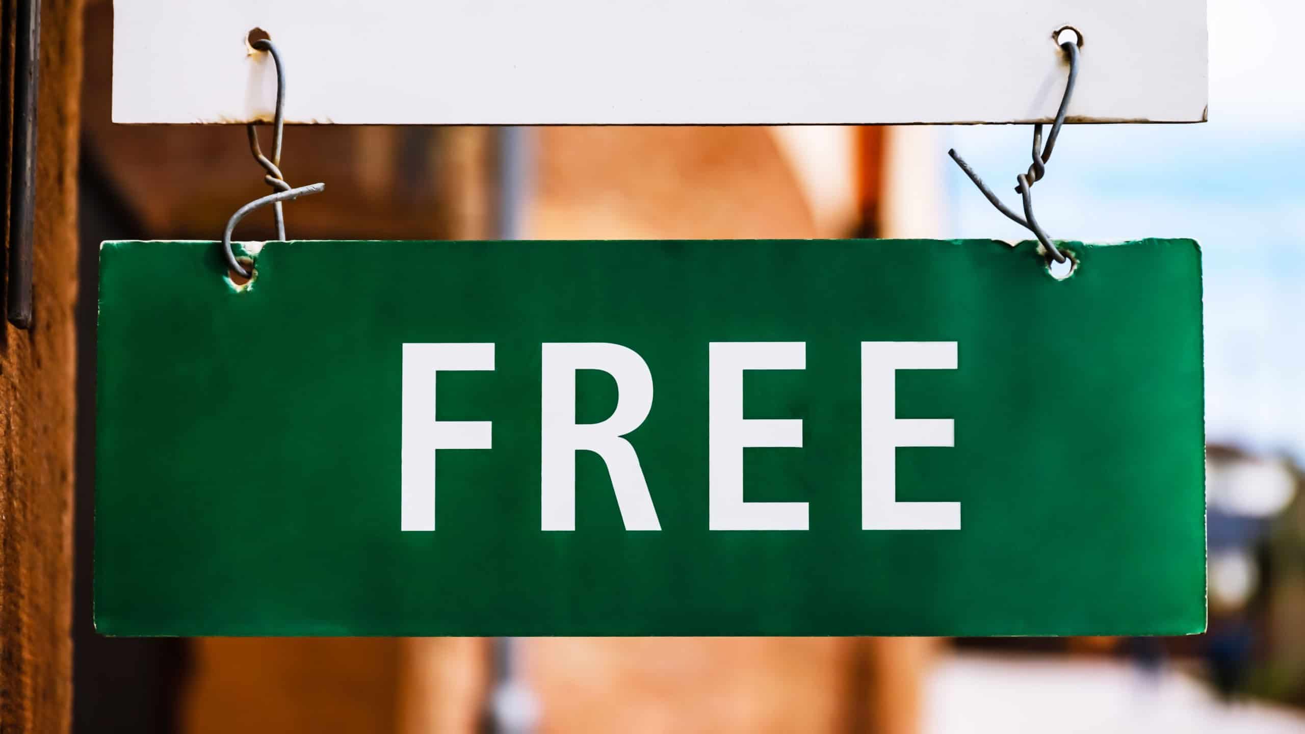 Green FREE sign hanging on door in resort area, rental room availability and vacation accommodation concept