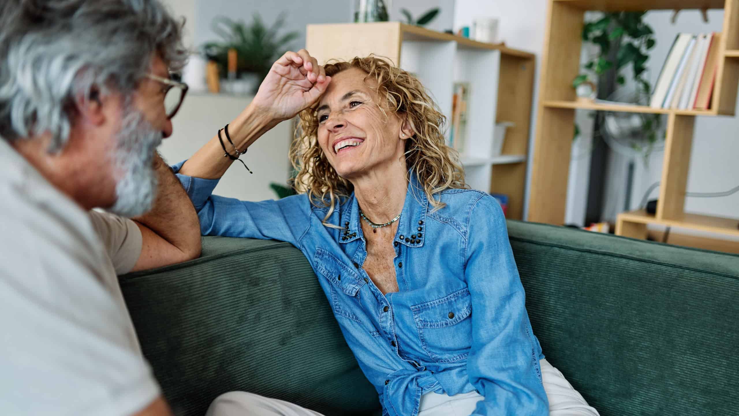 Portrait of a happy mature couple embracing talking at home