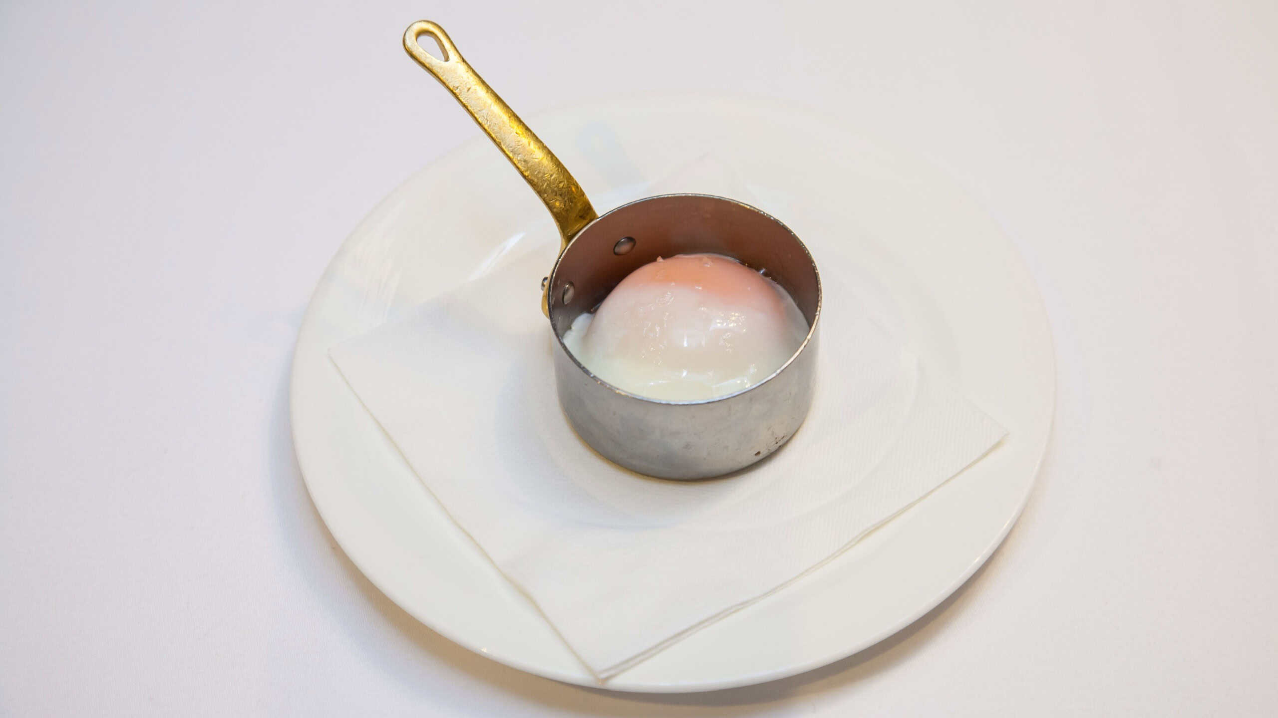 Medium rare egg in poaching tin