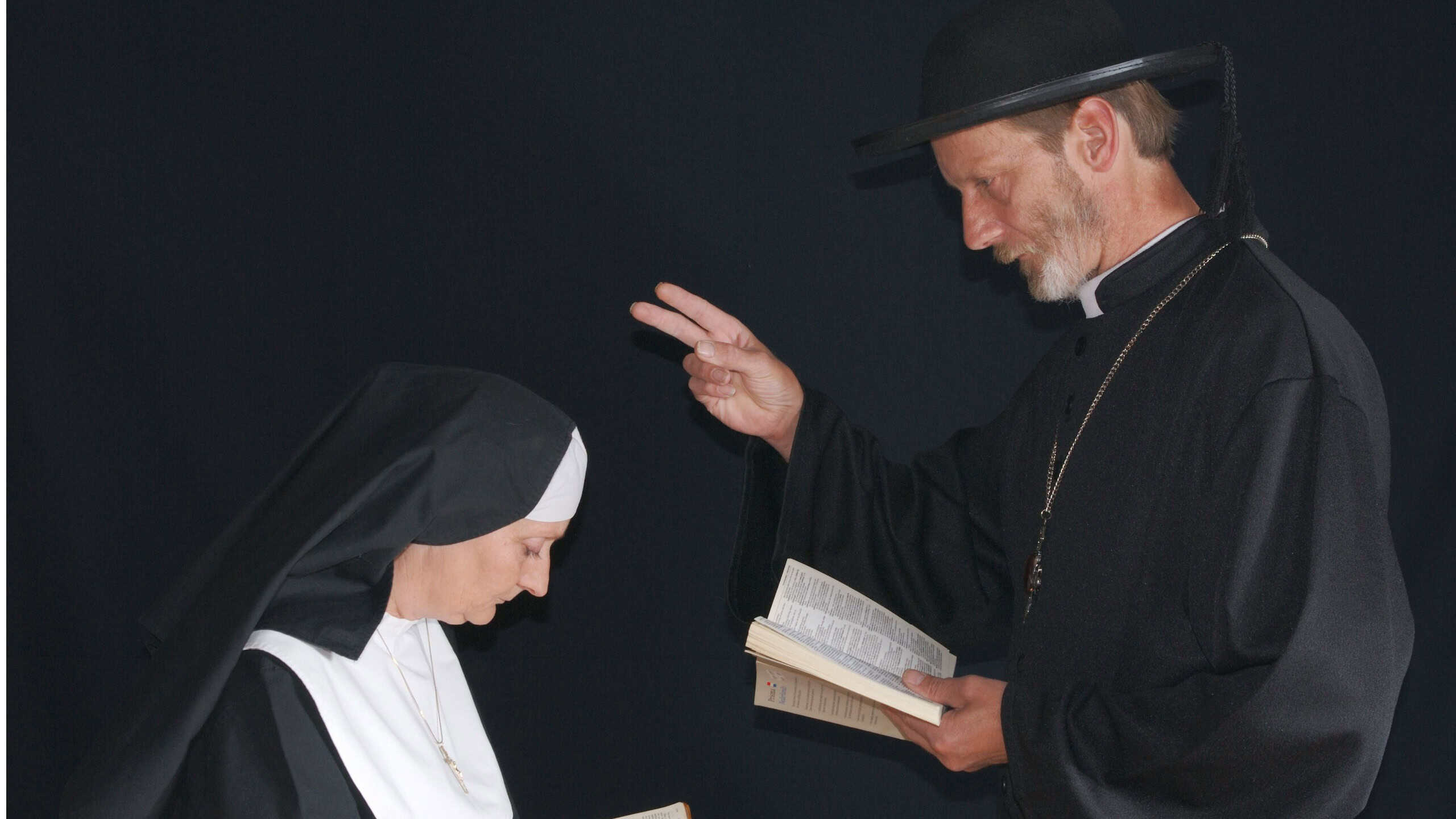 Middle aged devout nun and priest in deep thoughts, praying. Religion, christianity, lifestyle concept