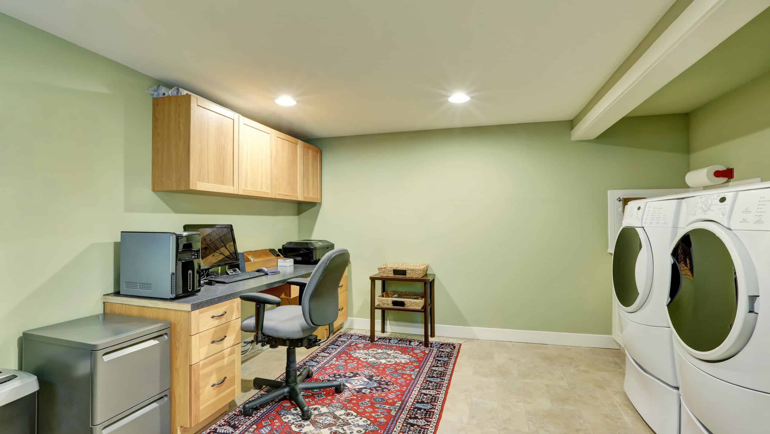 Basement room with combination of home office area and laundry appliances. Northwest, USA