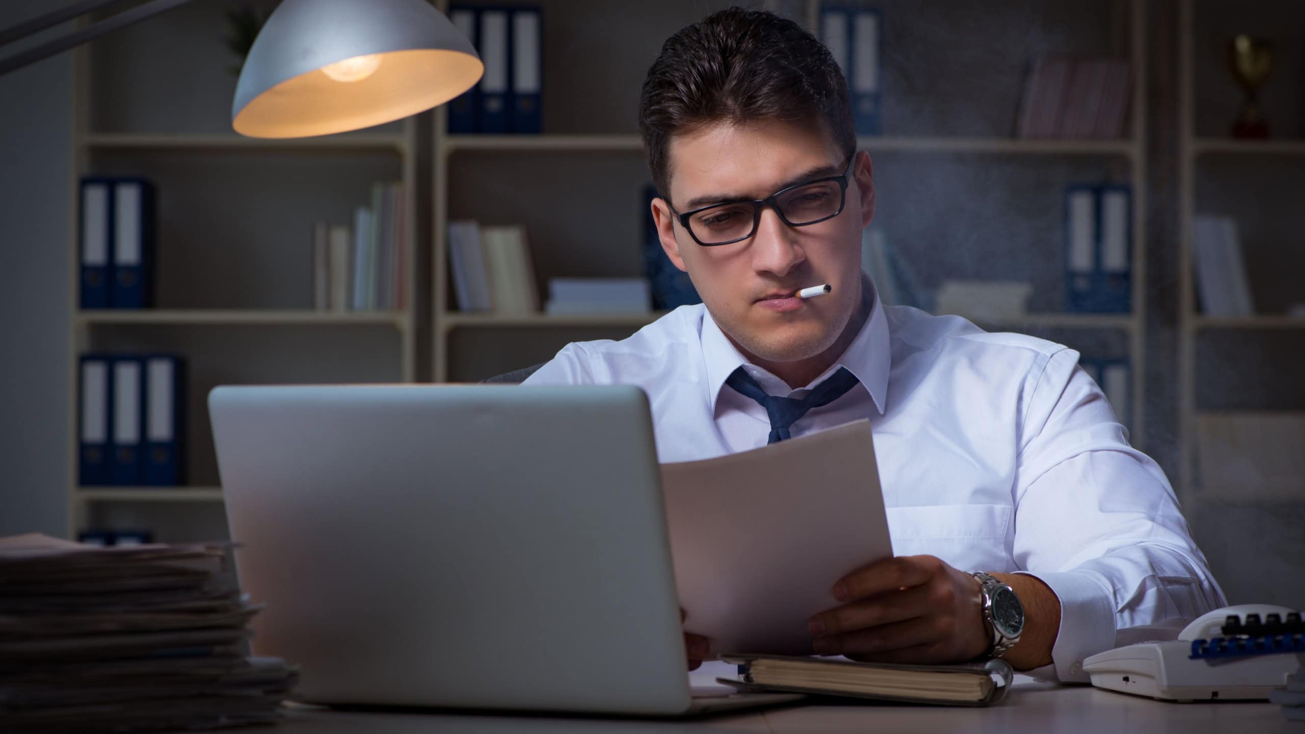 Businessman under stress smoking in office