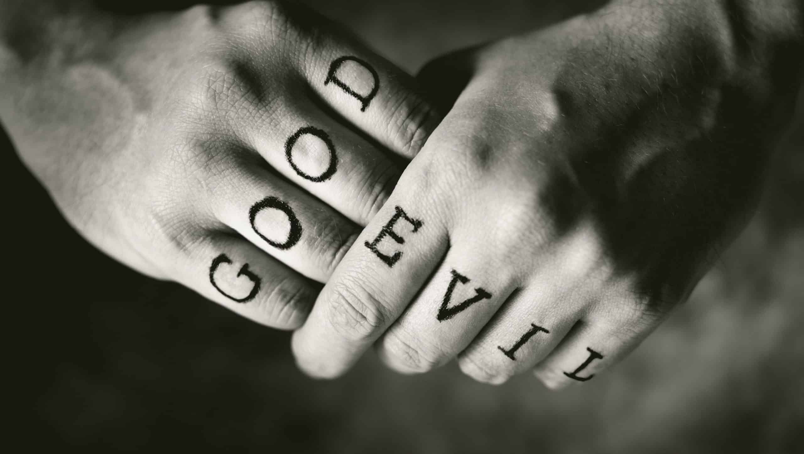 Man with "Good" and "Evil" (fake) tattoos on his fingers.