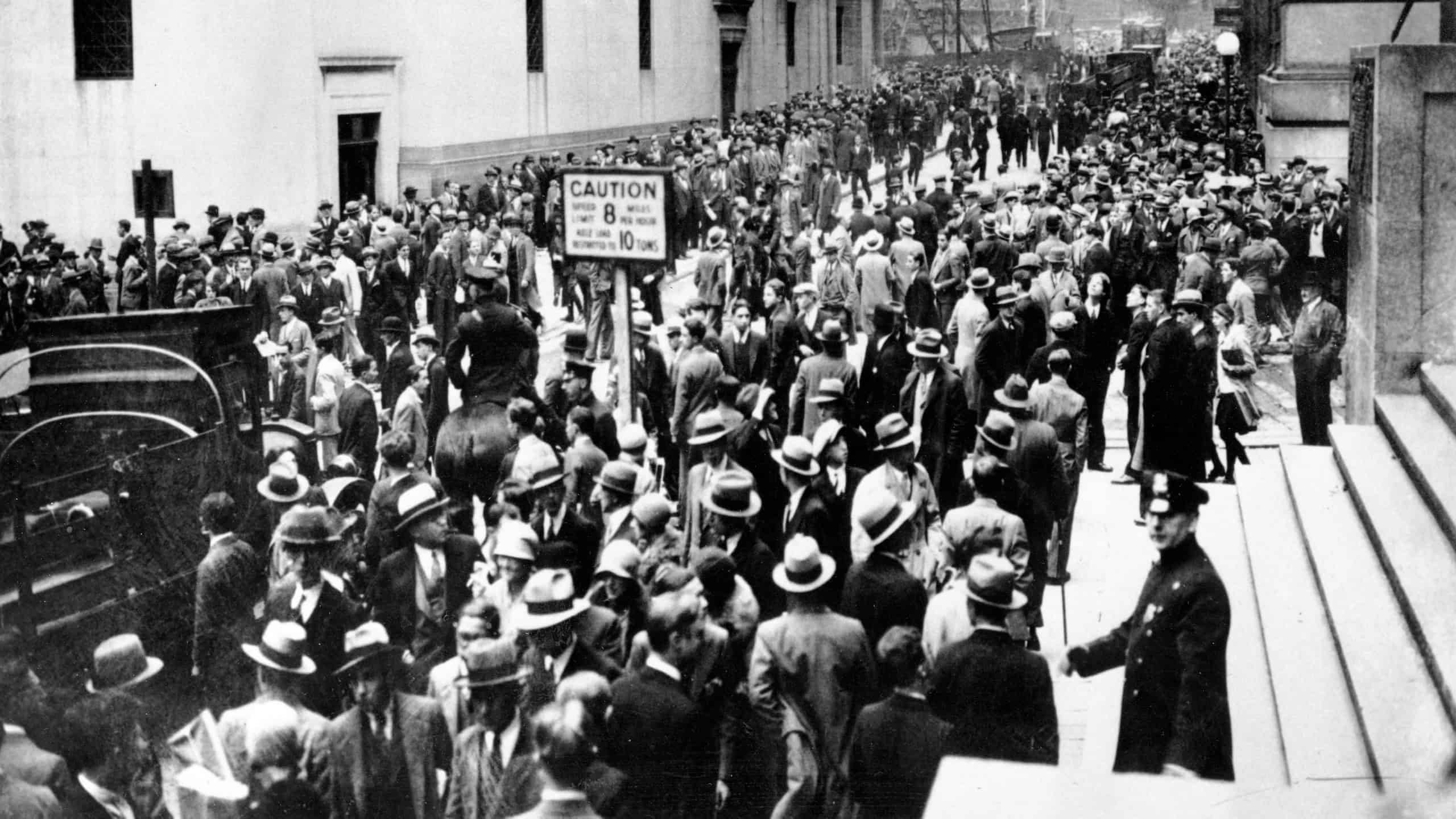 Crowds panic in the Wall Street district of Manhattan due to the heavy trading on the stock market in New York City on Oct. 24, 1929.