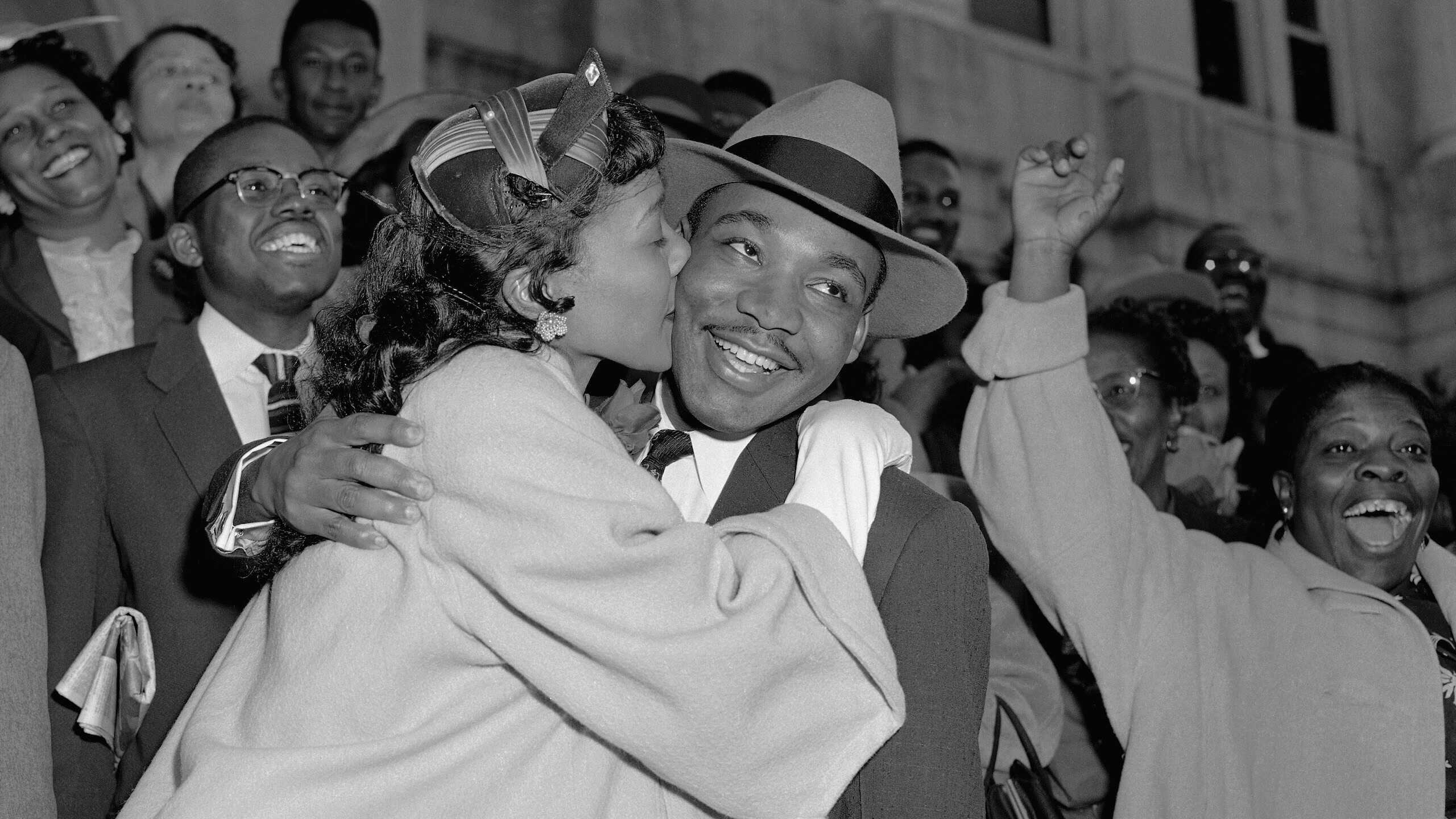 Martin Luther King Jr. is welcomed with a kiss from his wife, Coretta Scott King, after leaving court in Montgomery, AL, on March 22, 1956