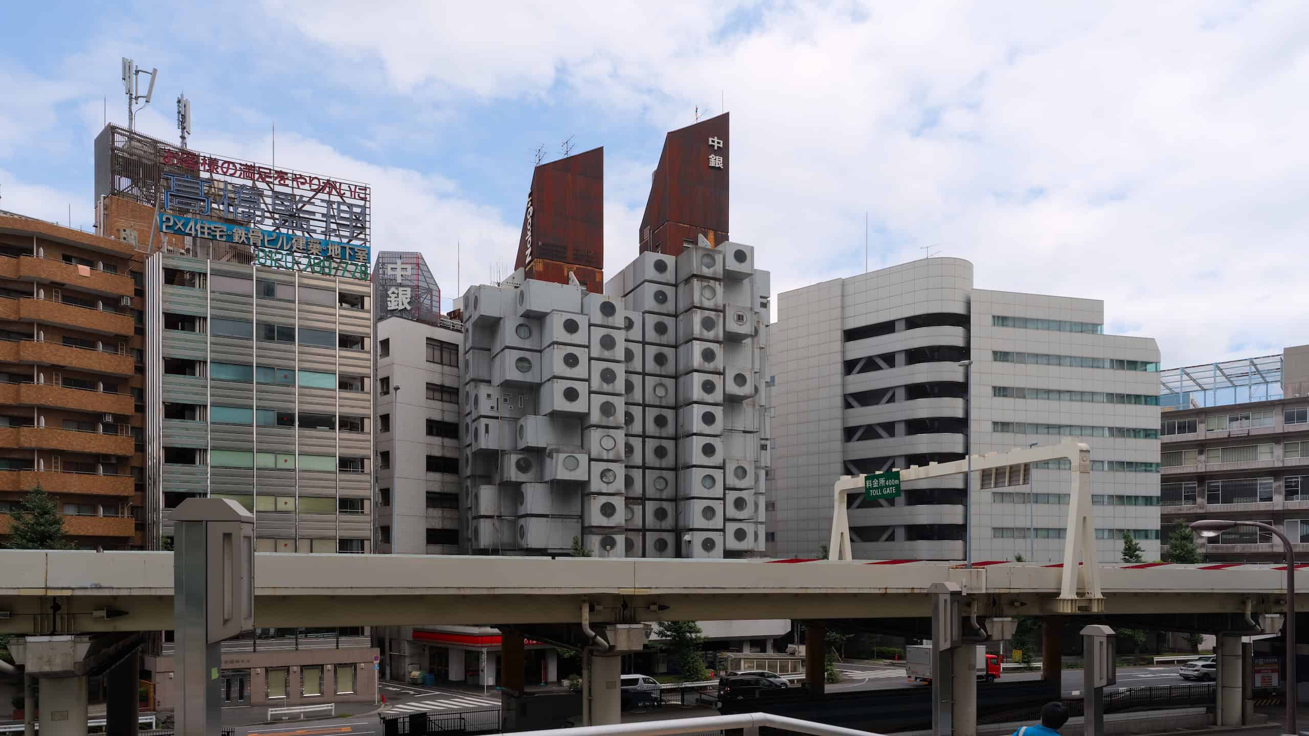 Wide angle shot of the Nakagin Capsule Tower in 2017.
