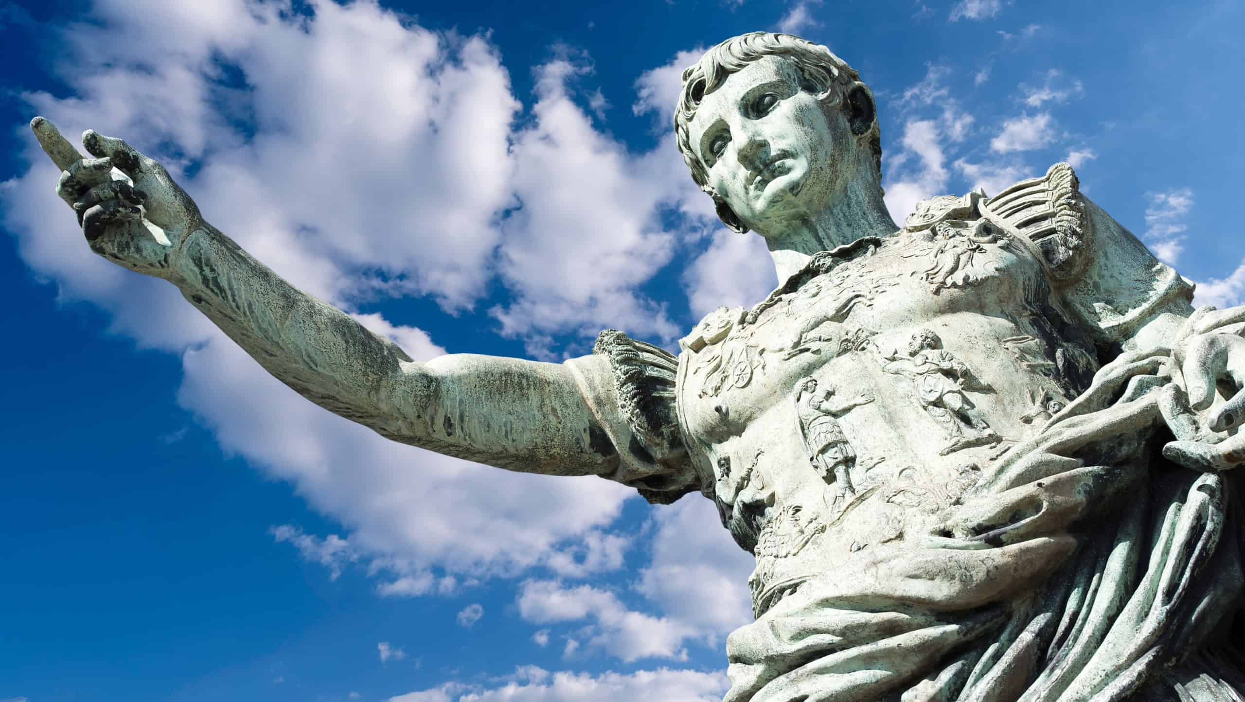 Ancient statue of Julius Caesar against blue Sky in Italy