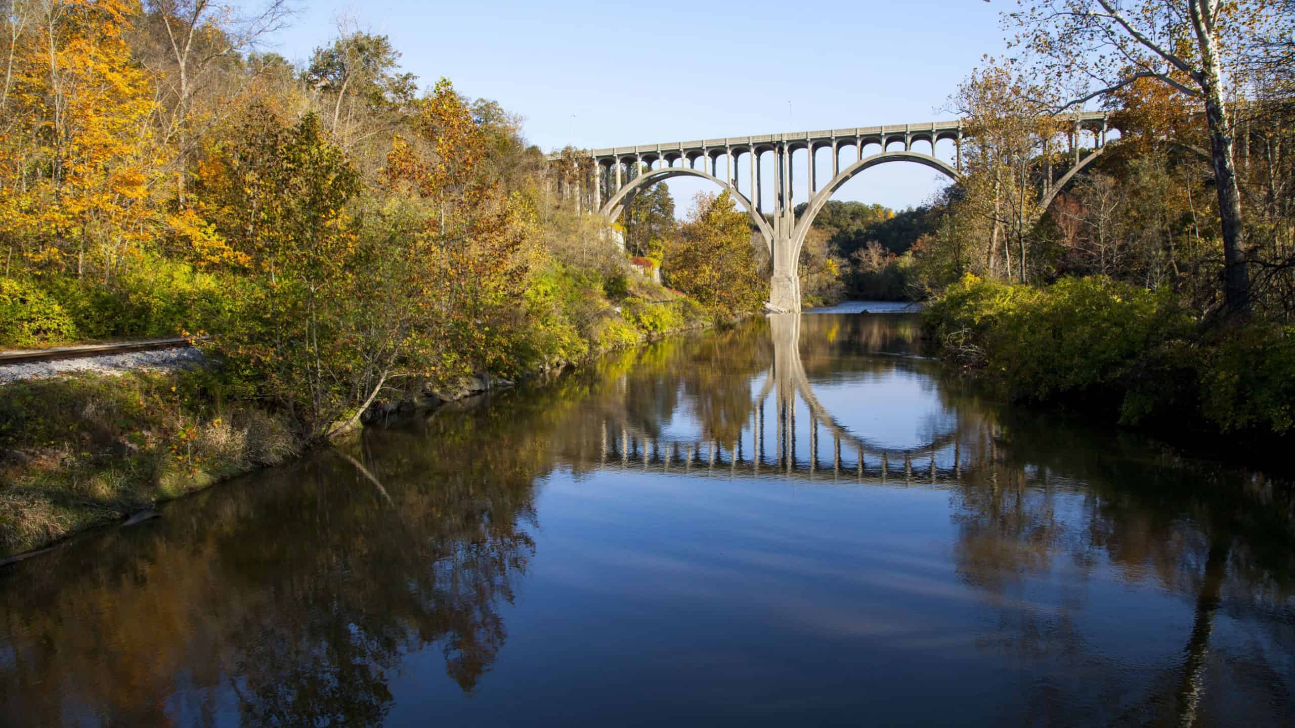 A beautiful shot of a bridge reflecting in the Cuyahoga River in Ohio on a beautiful autumn day