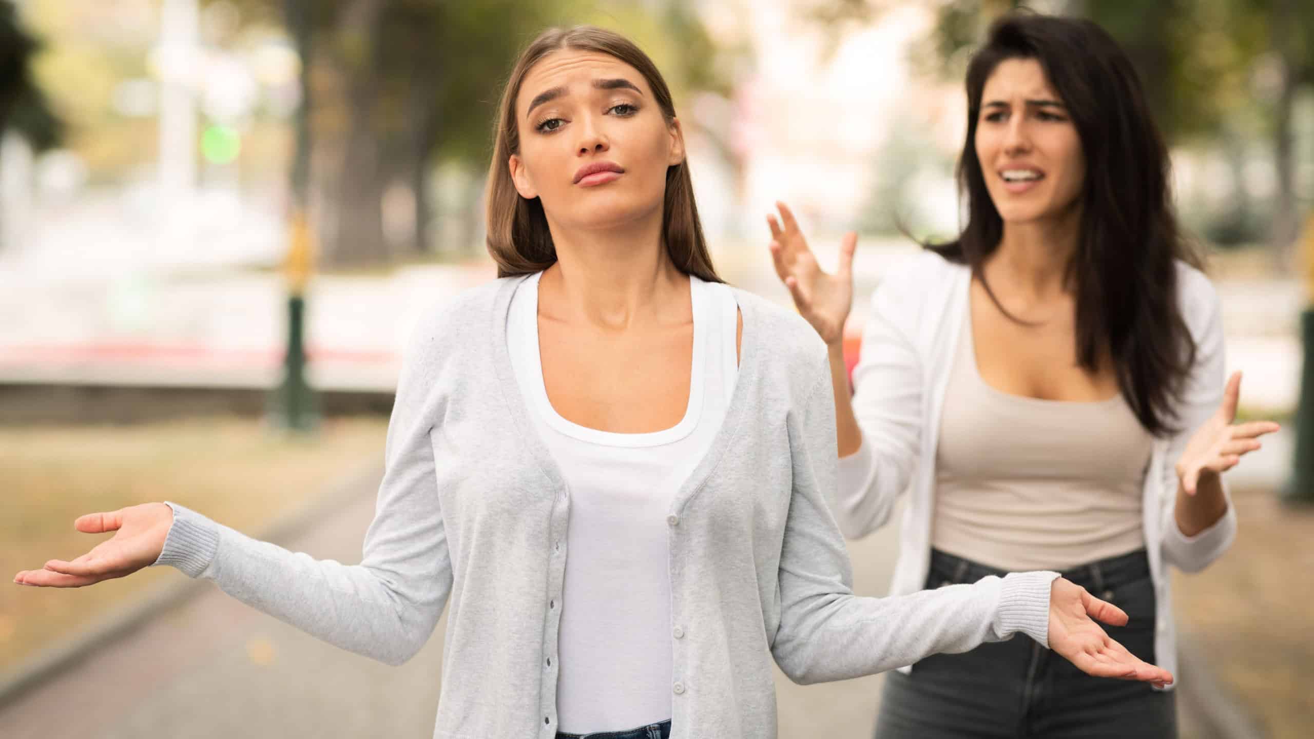 End Of Friendship. Two Girls Having Quarrel Standing Outside In Park. Selective Focus