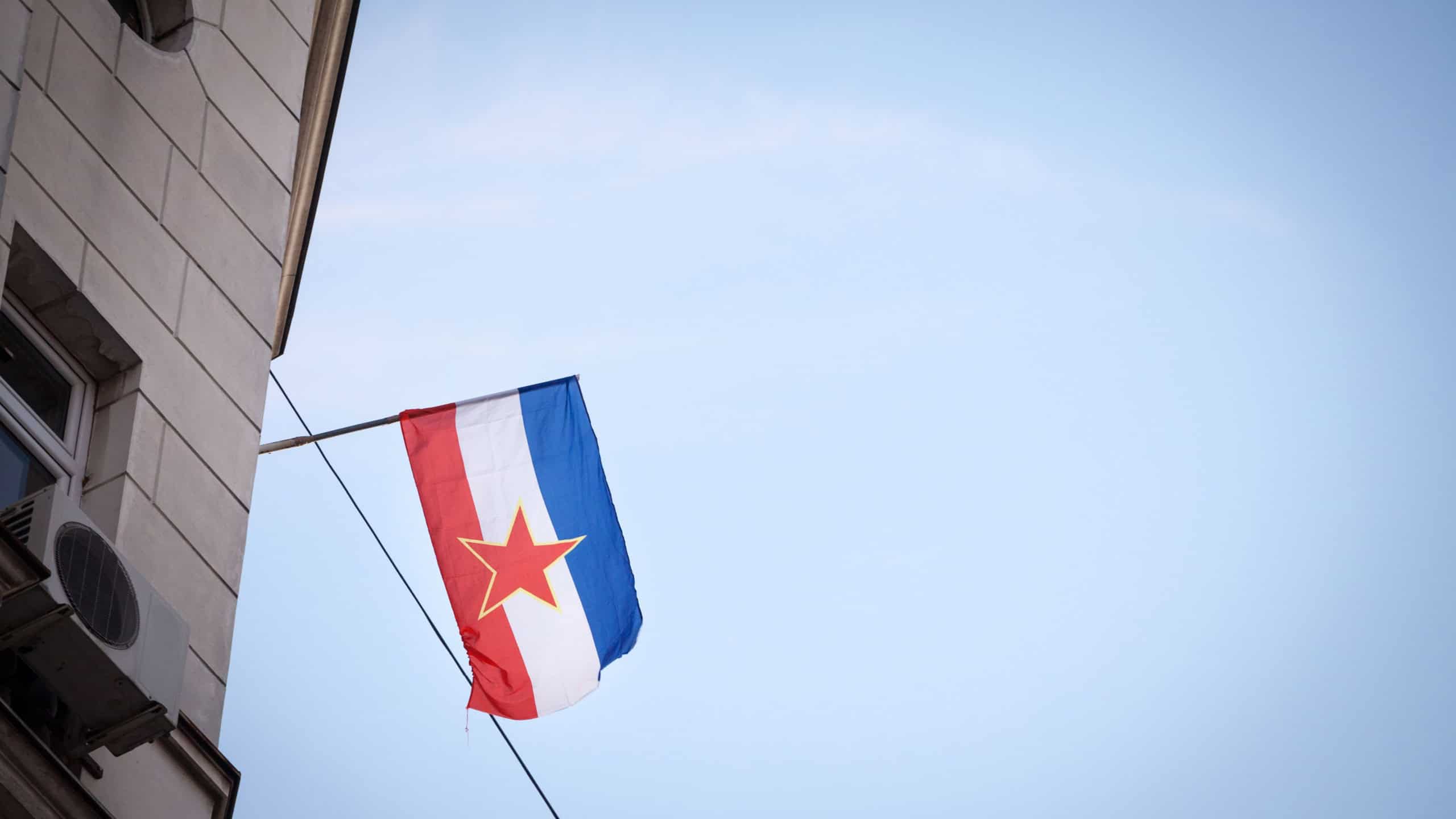 Yugoslav flag, with the red star of the communist socialist federal republic of yugoslavia (SFRY), waving in Belgrade, the former capital city of this disappeared state.