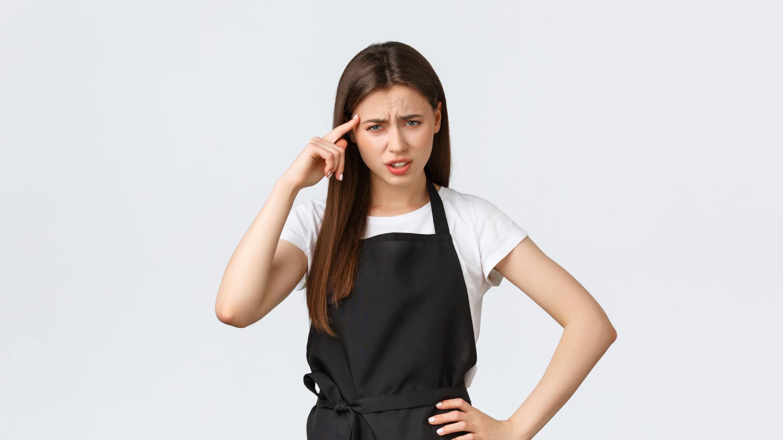 Grocery store employees, small business and coffee shops concept. Young annoyed barista complaining on someone acting stupid. Saleswoman roll finger over temple irritated