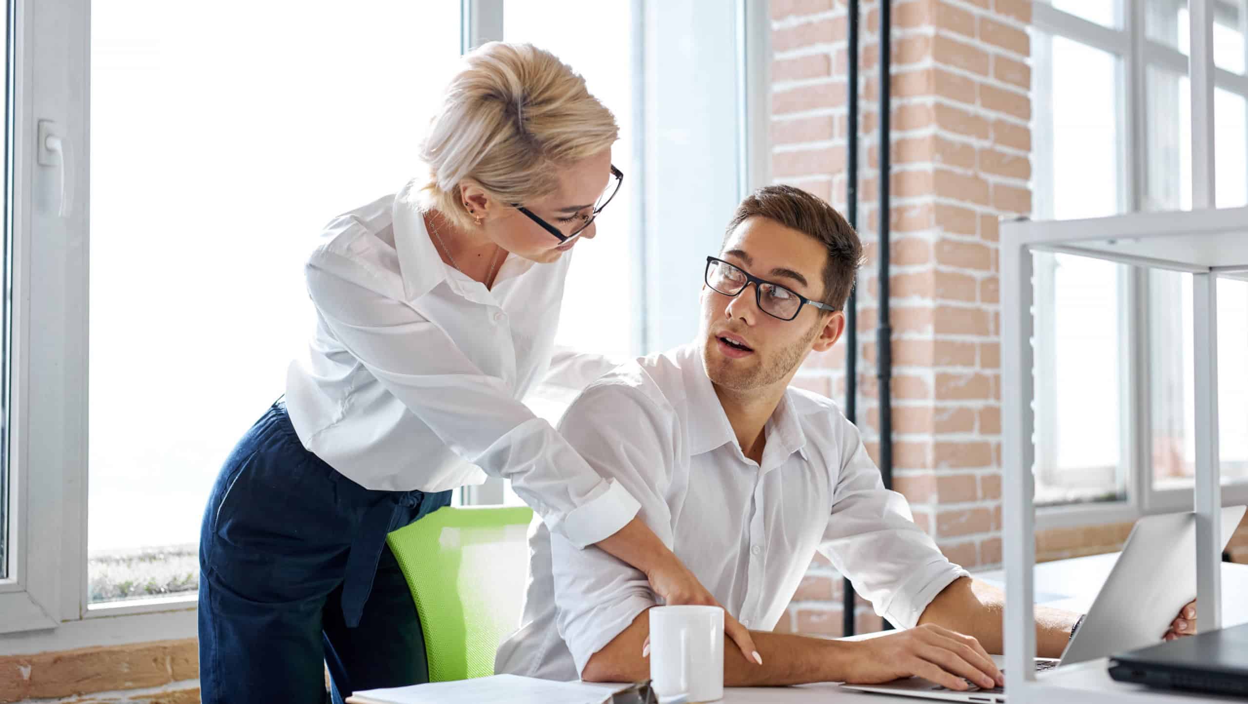subordinate relations. nice caucasian unpleasant adult woman showing her sexual interest to male employee, touch him