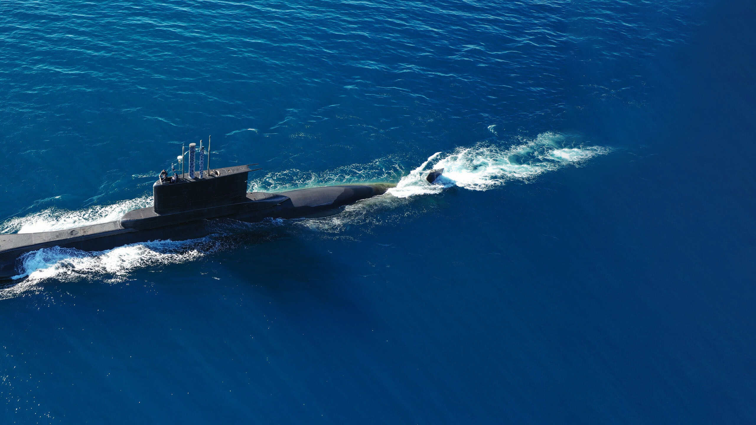 Aerial drone ultra wide photo of latest technology naval armed forces submarine cruising in deep blue open ocean sea