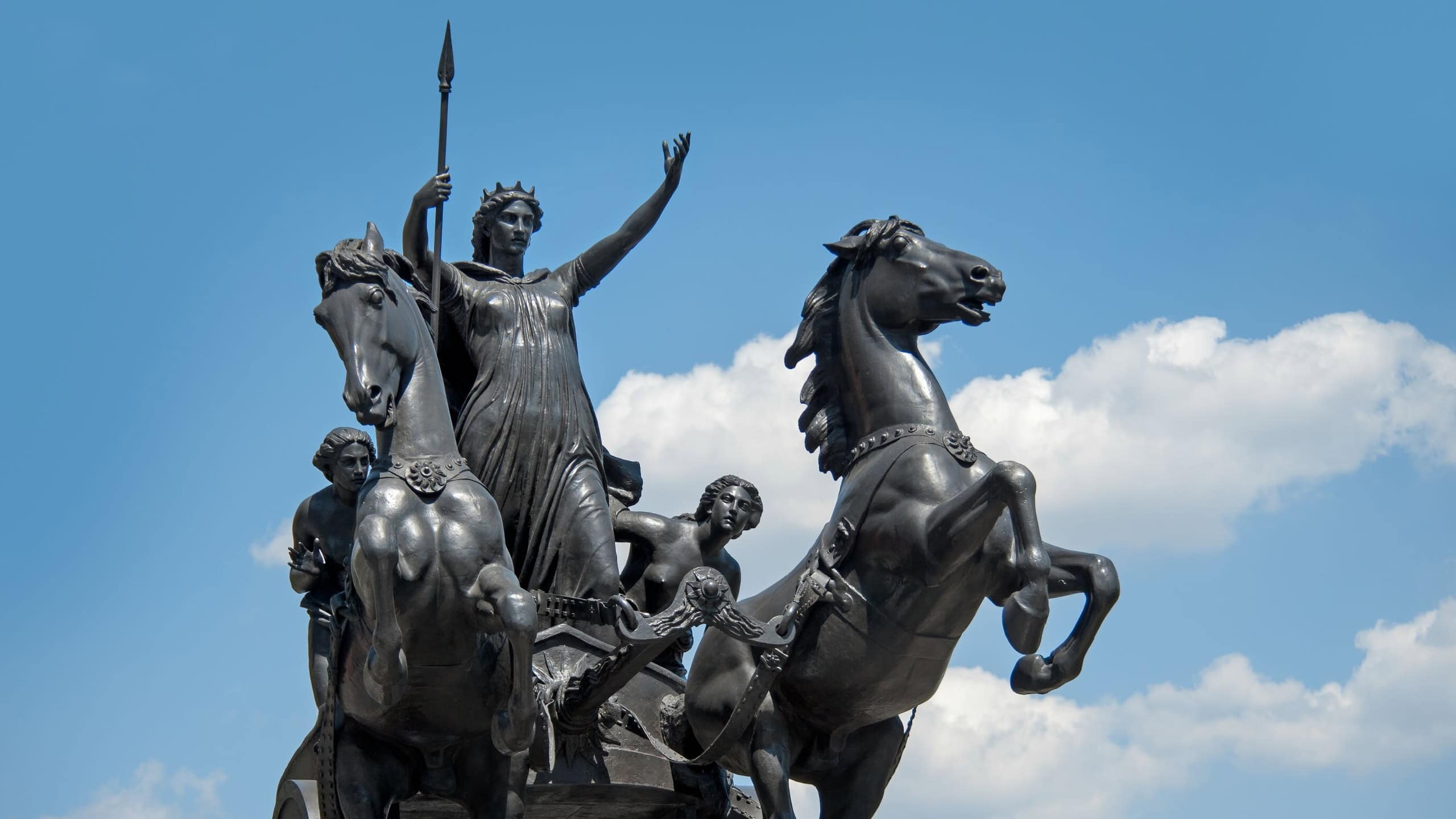 Statue of Queen Boudicca in a chariot on Westminster Bridge against blue sky
