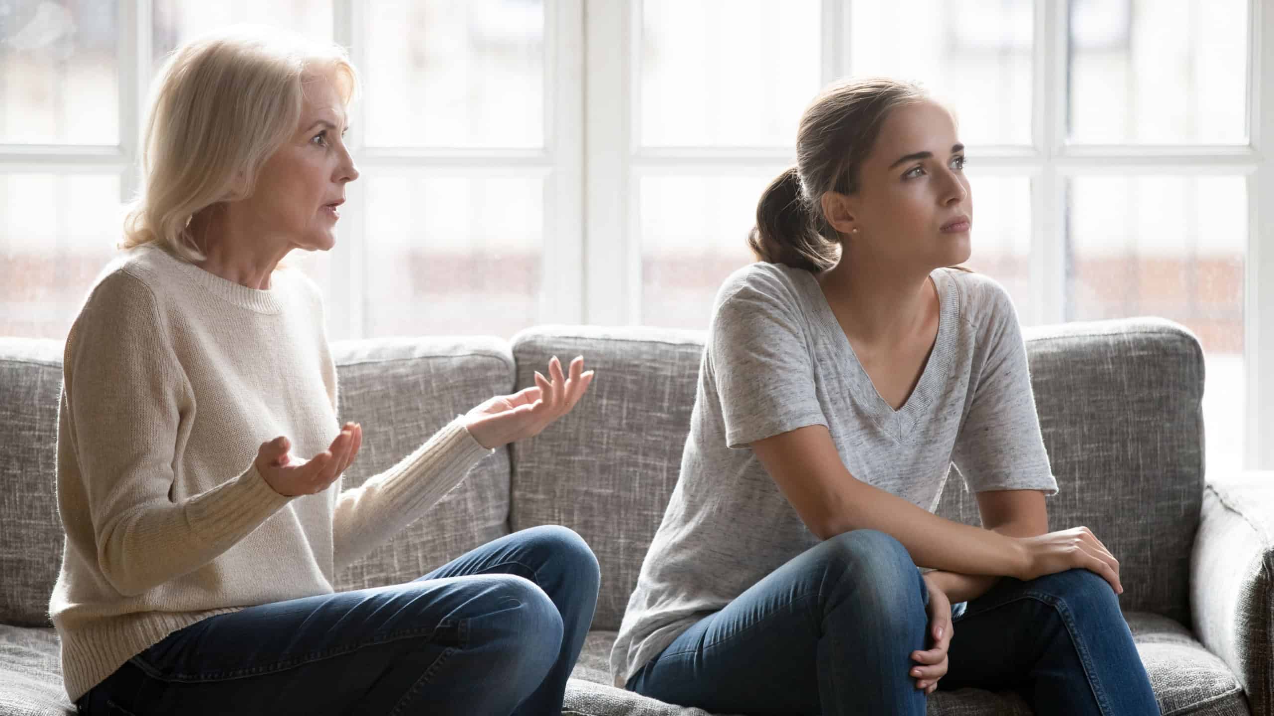 Senior Caucasian mother and grownup daughter have family quarrel fight at home. Mature mom talk to ignorant stubborn adult female child avoid communication. Misunderstanding, generation gap concept.