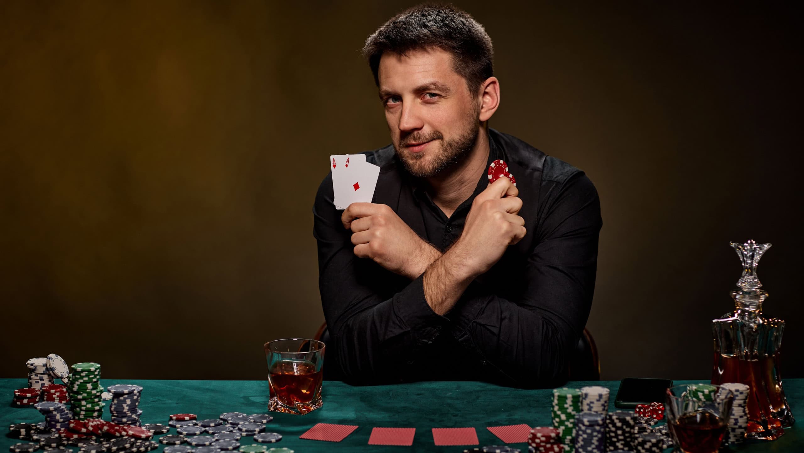 Bearded casino player man playing poker on green table